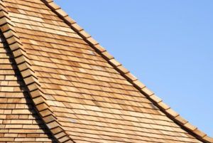 Wooden shingle roof against a clear blue sky.