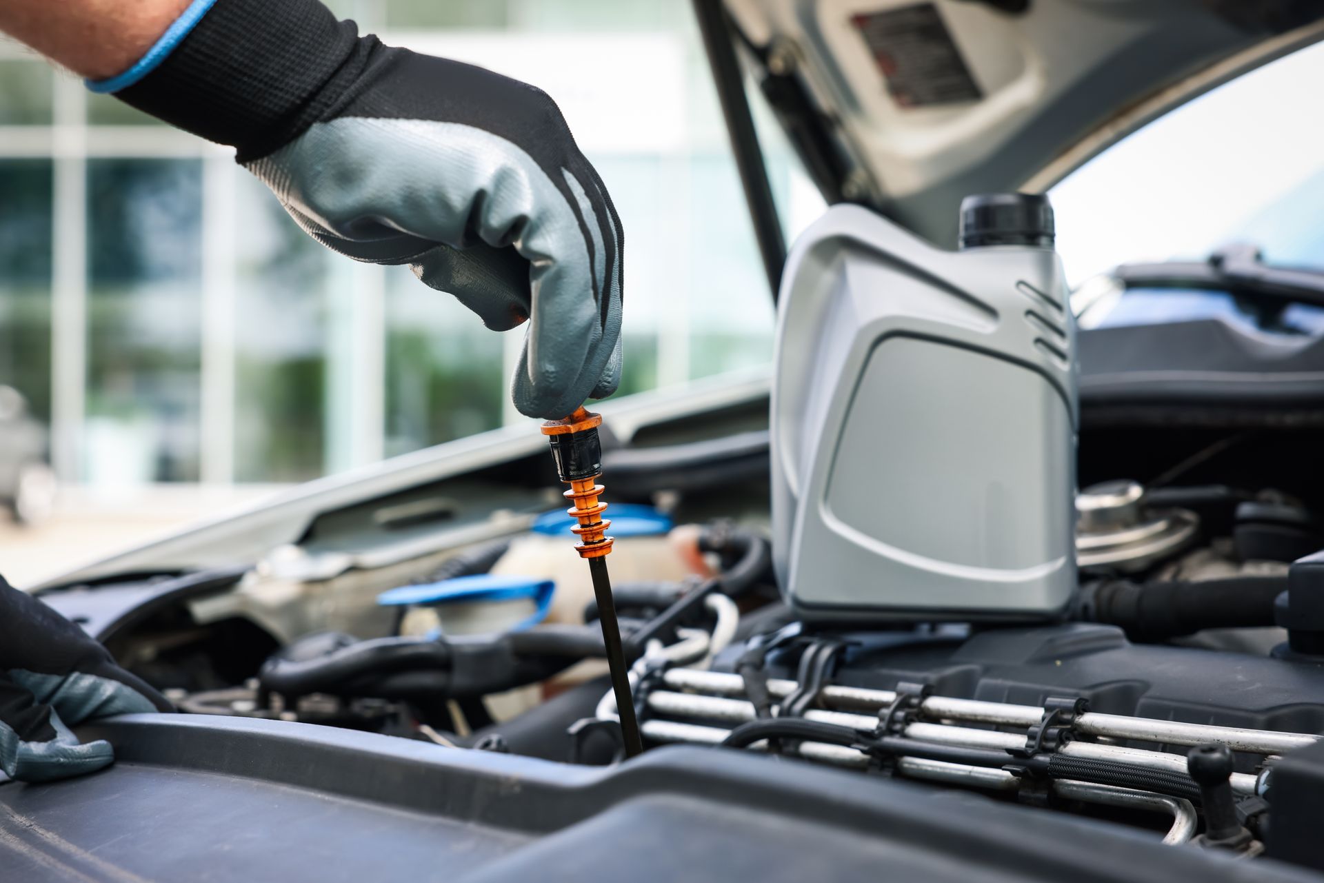Mechanic changing the oil | EG Auto Center
