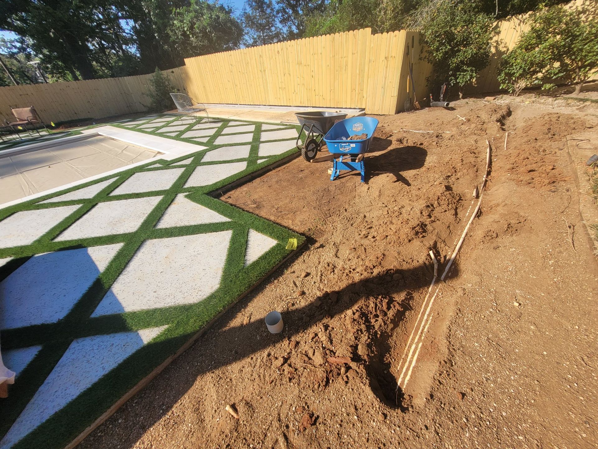 A sprinkler is spraying water on a lush green lawn.