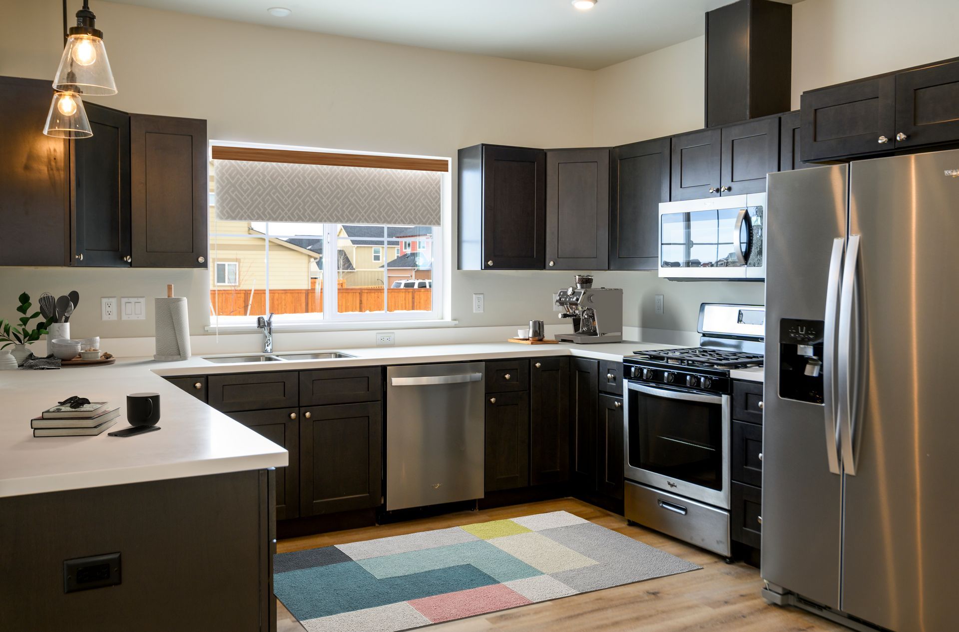 Updated kitchen at The Grange apartments with stainless steel appliances and modern finishes.