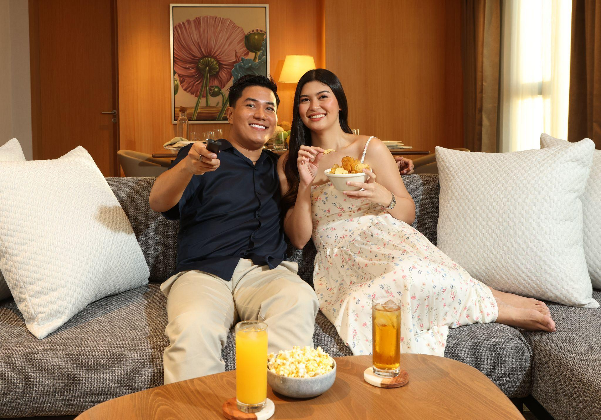Couple unwinding on the sofa of an Alino Hotel suite