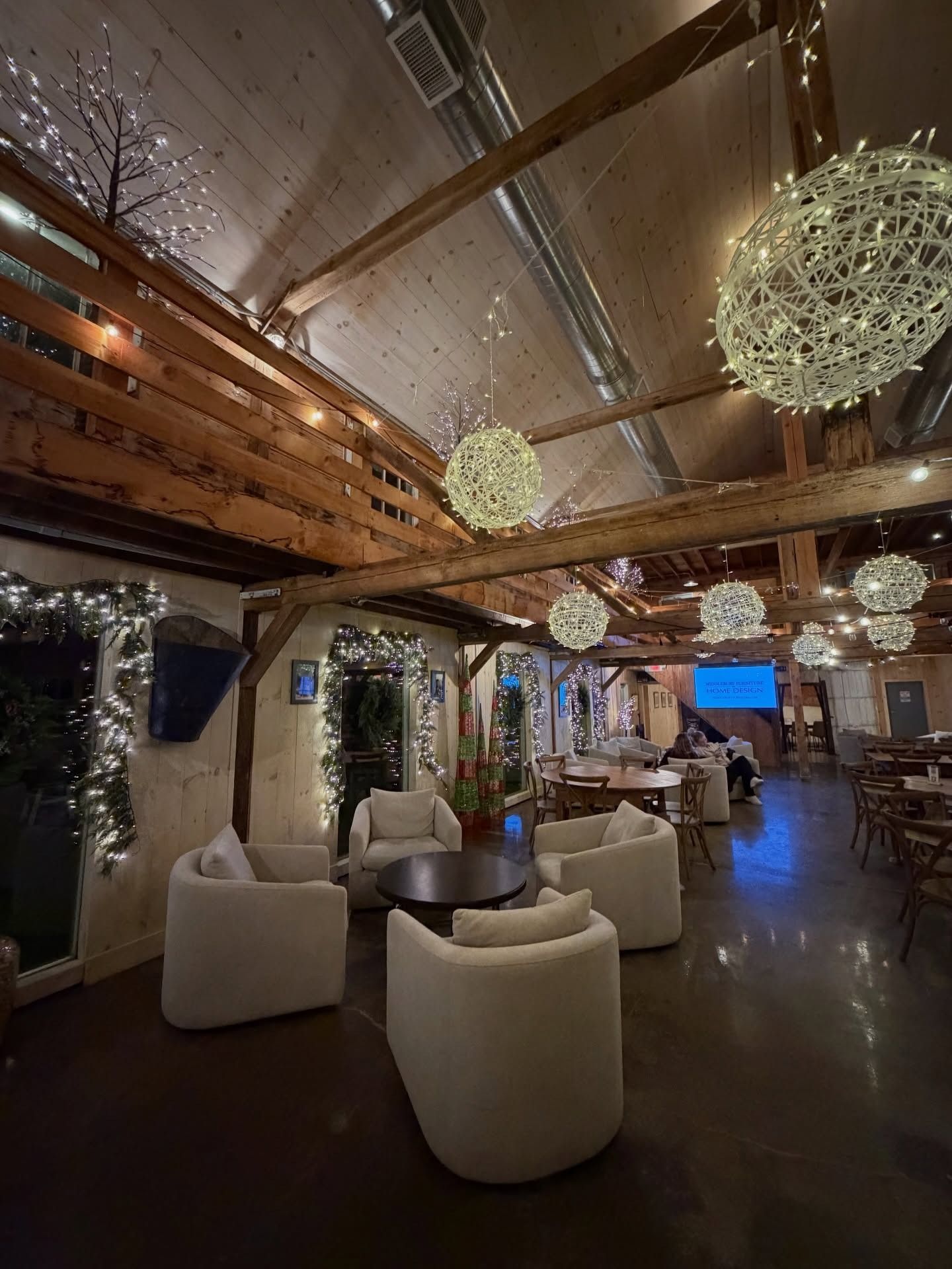 A man and a woman are sitting at a table toasting with wine glasses