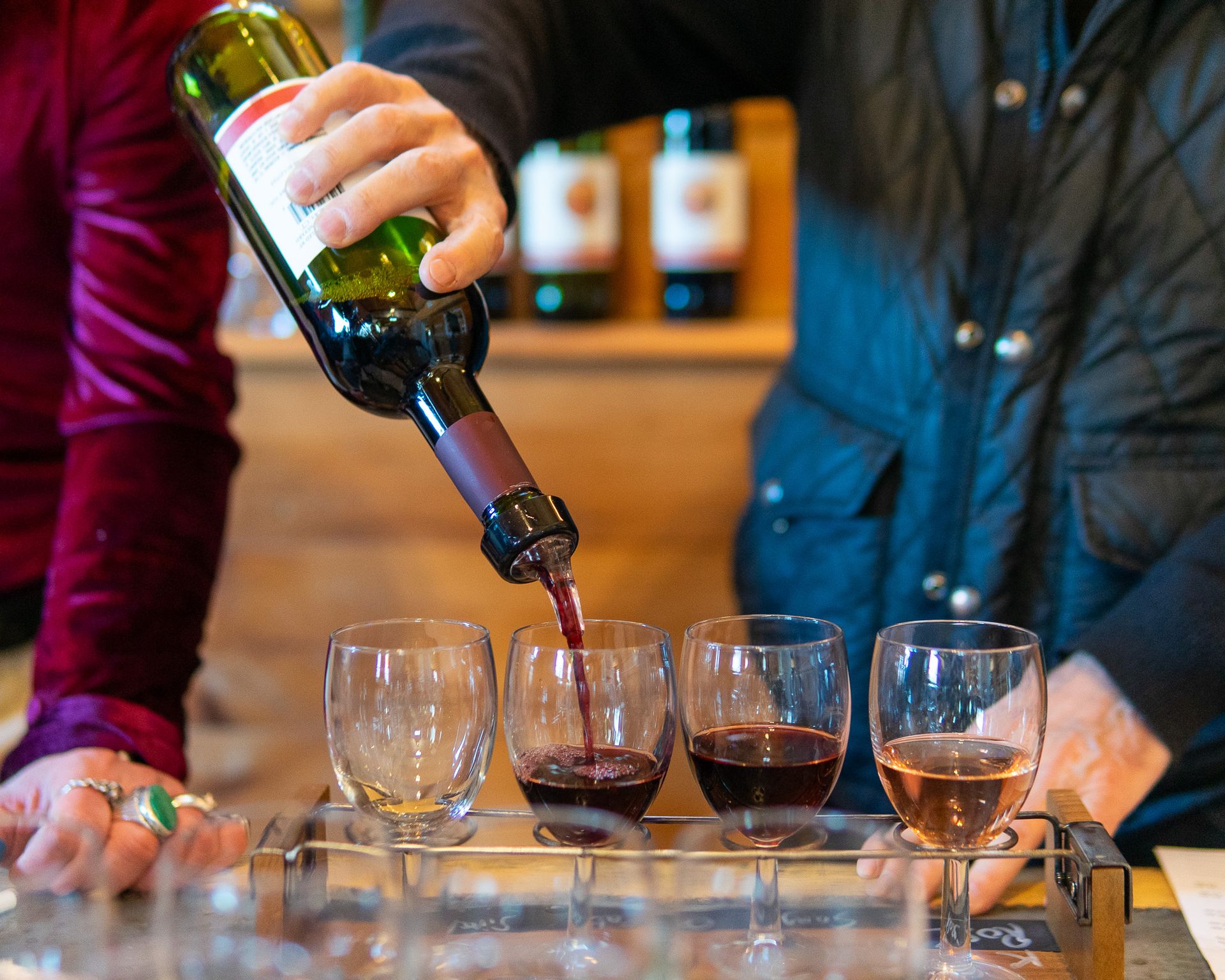 A woman is dancing in front of a group of people in a vineyard.