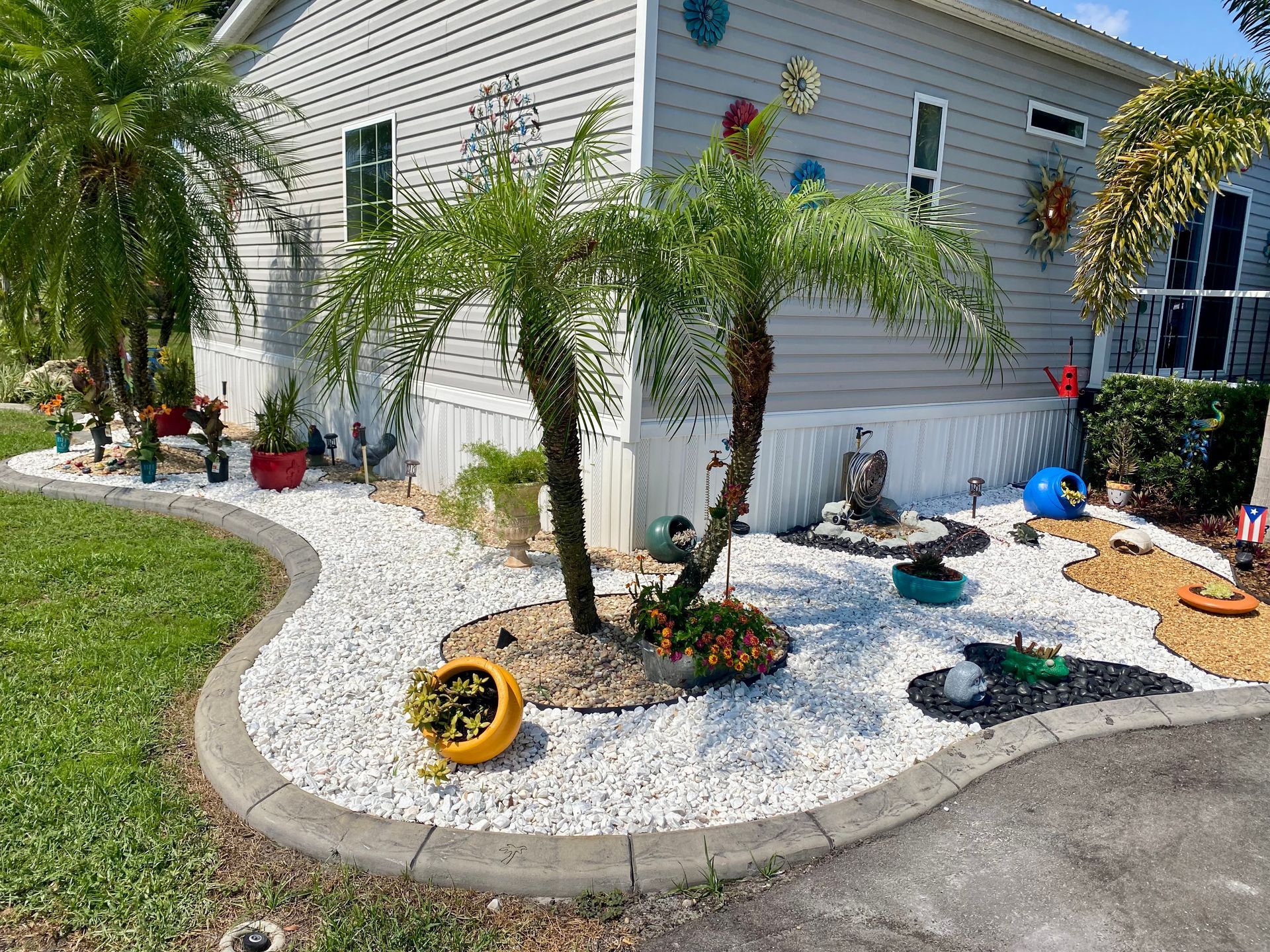 A mobile home with a garden in front of it.