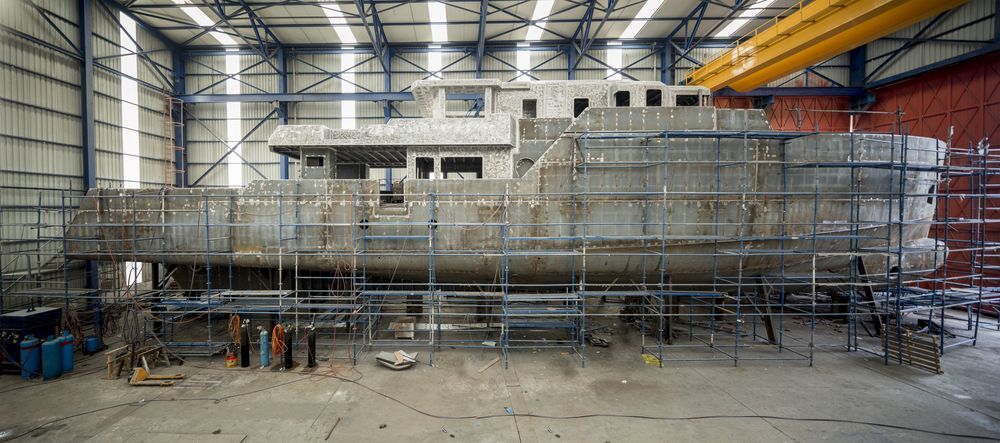 A Large Boat is Being Built in a Warehouse With Scaffolding — On Demand Diggers & Demolitions in Sunshine Coast, QLD