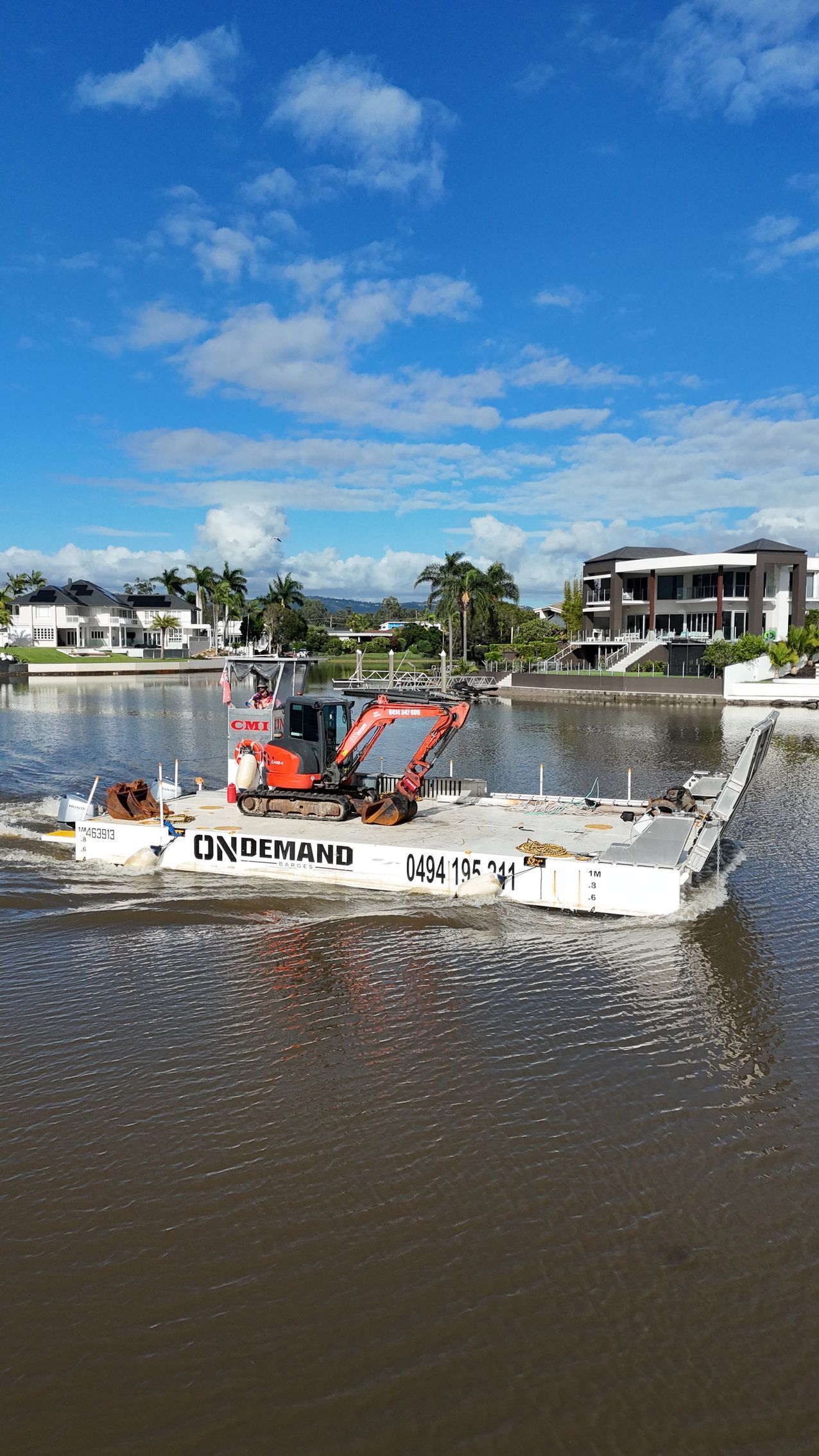 Excavator on a Barge Dredges Murky Water in a Canal — On Demand Diggers and Demolitions in Molendinar, QLD