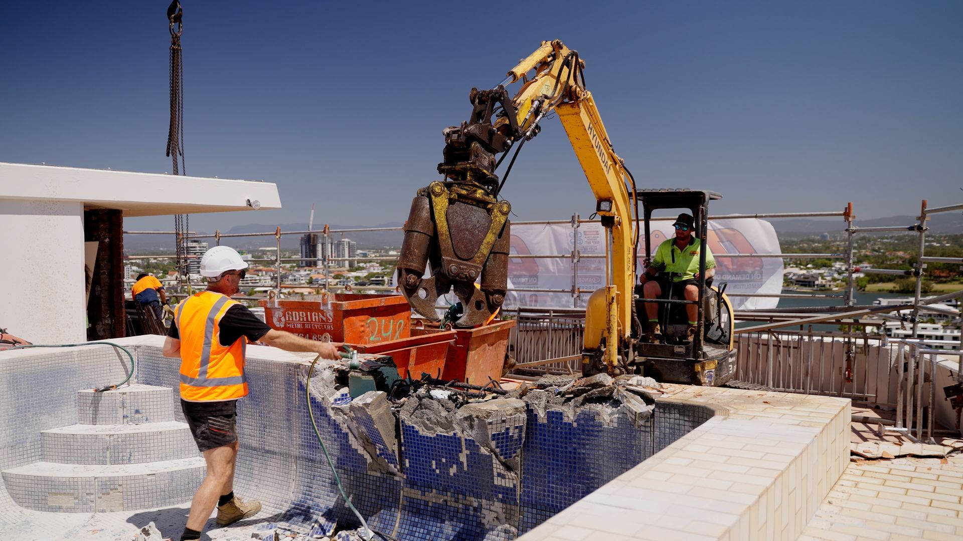 A Man is Kneeling Down on a Ship Working on a Pipe — On Demand Diggers & Demolitions in Molendinar, QLD
