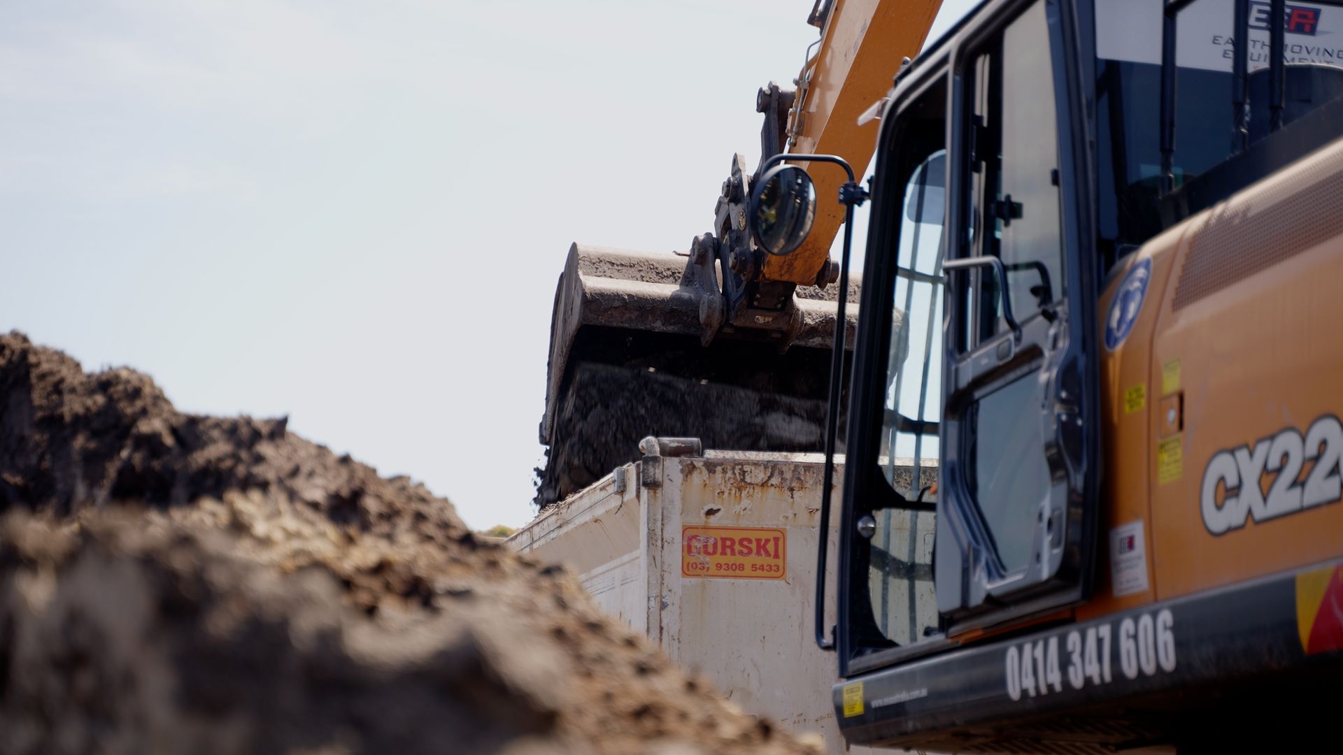 Yellow Excavator is Digging a Hole in a Dirt Field — On Demand Diggers & Demolitions in Molendinar, QLD