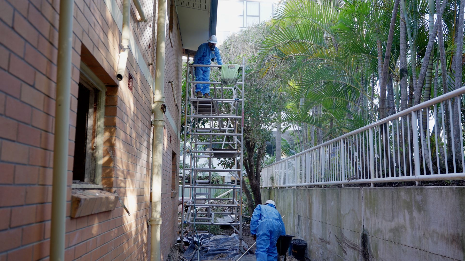 Group of People in Protective Suits Are Working on a Roof — On Demand Diggers & Demolitions in Sunshine Coast, QLD