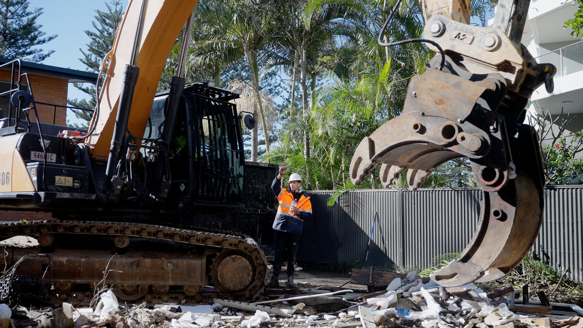 A Man is Working on a Boat in a Garage — On Demand Diggers & Demolitions in Molendinar, QLD