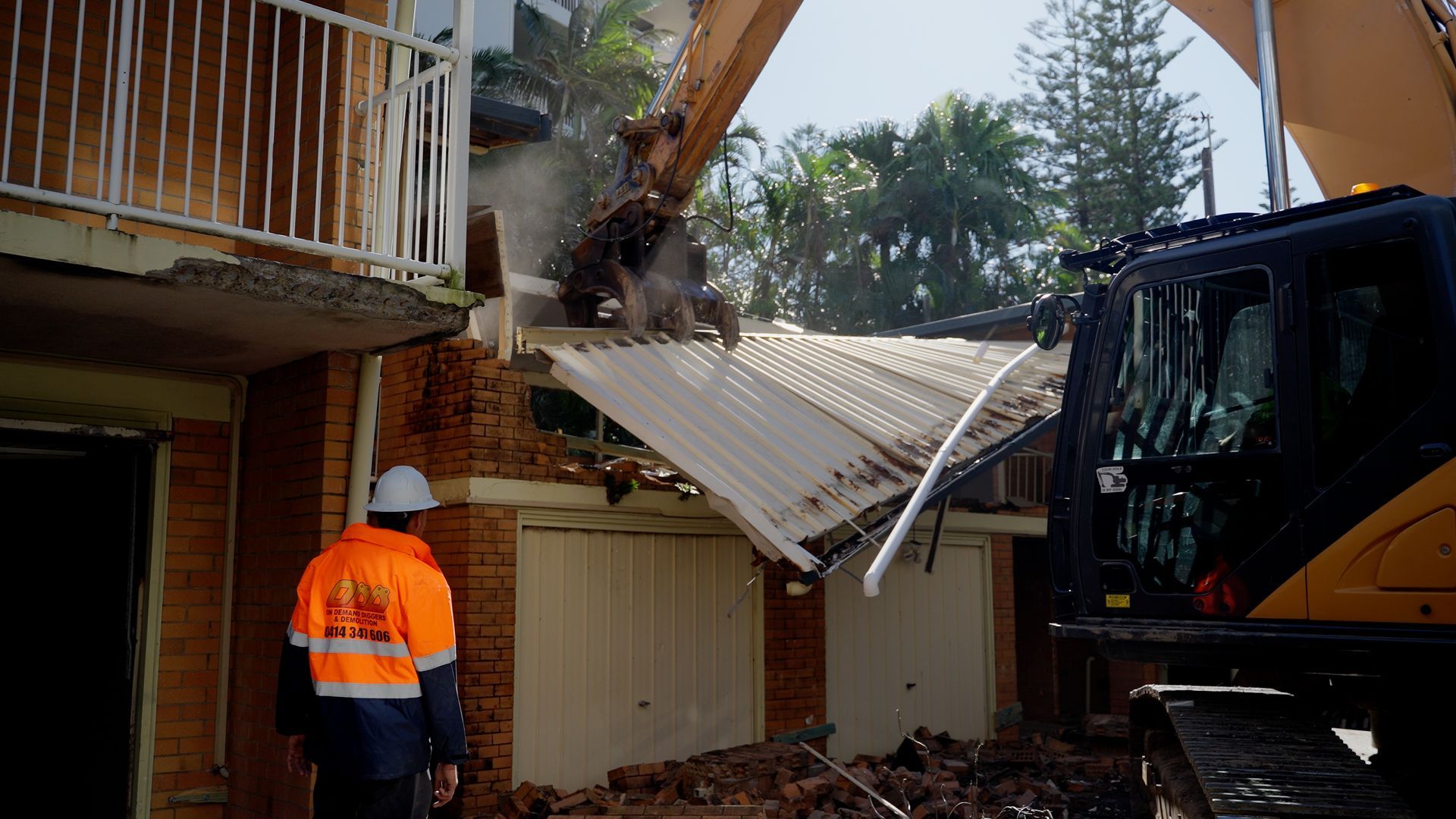 Large Excavator is Demolishing a Yellow House — On Demand Diggers & Demolitions in Molendinar, QLD