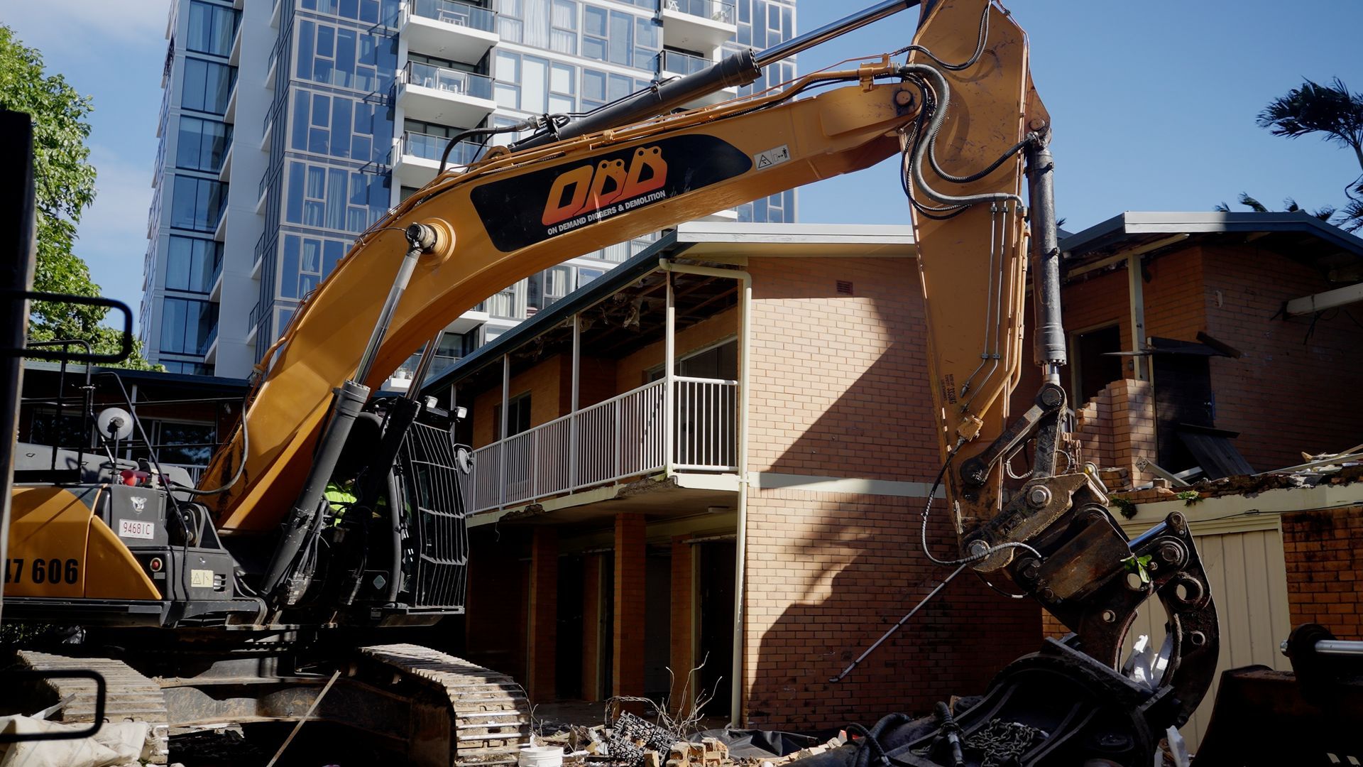 Yellow and Orange Excavator is Demolishing a Building — On Demand Diggers & Demolitions in Molendinar, QLD