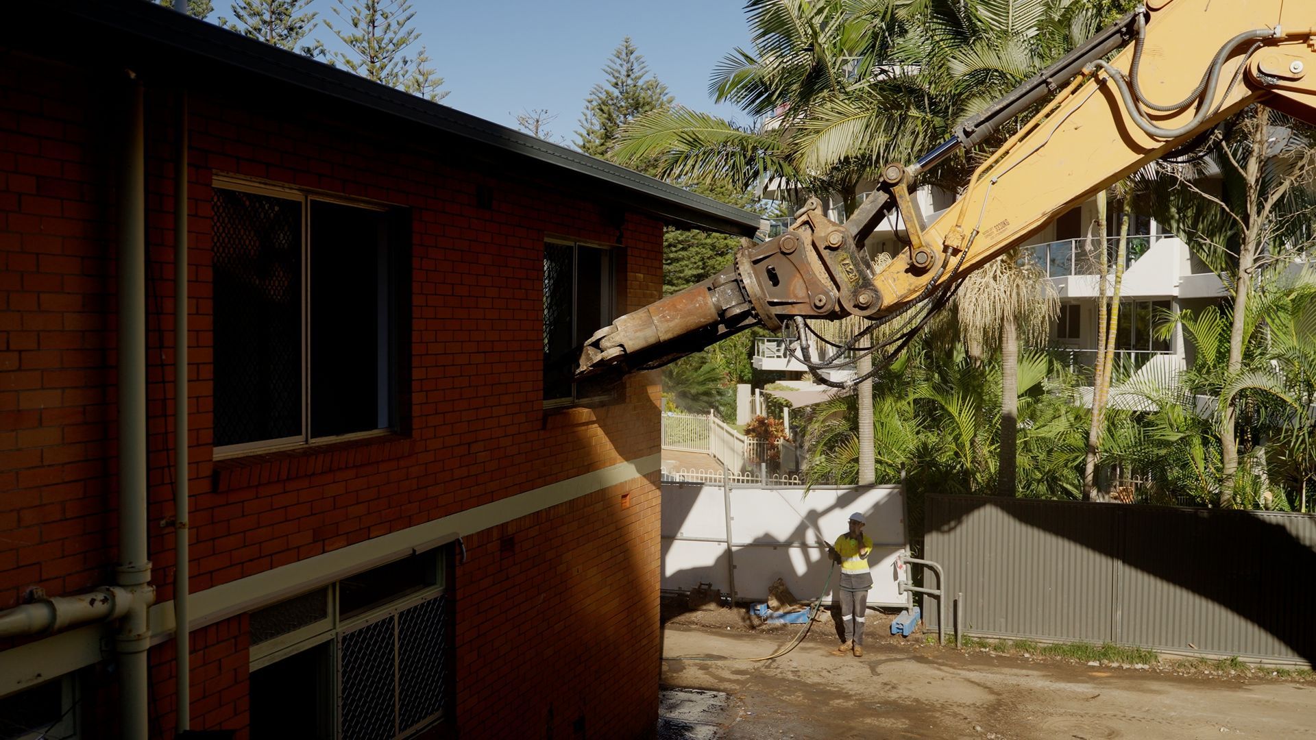 Small Orange Bulldozer is Driving Through a Muddy Field in the Woods — On Demand Diggers & Demolitions in Sunshine Coast, QLD