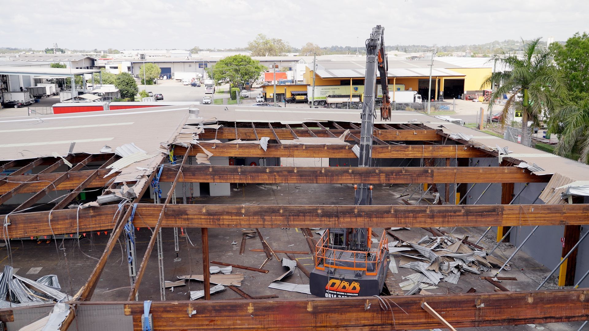 Large Orange Excavator is Digging a Hole in a Construction Site — On Demand Diggers & Demolitions in Gold Coast, QLD