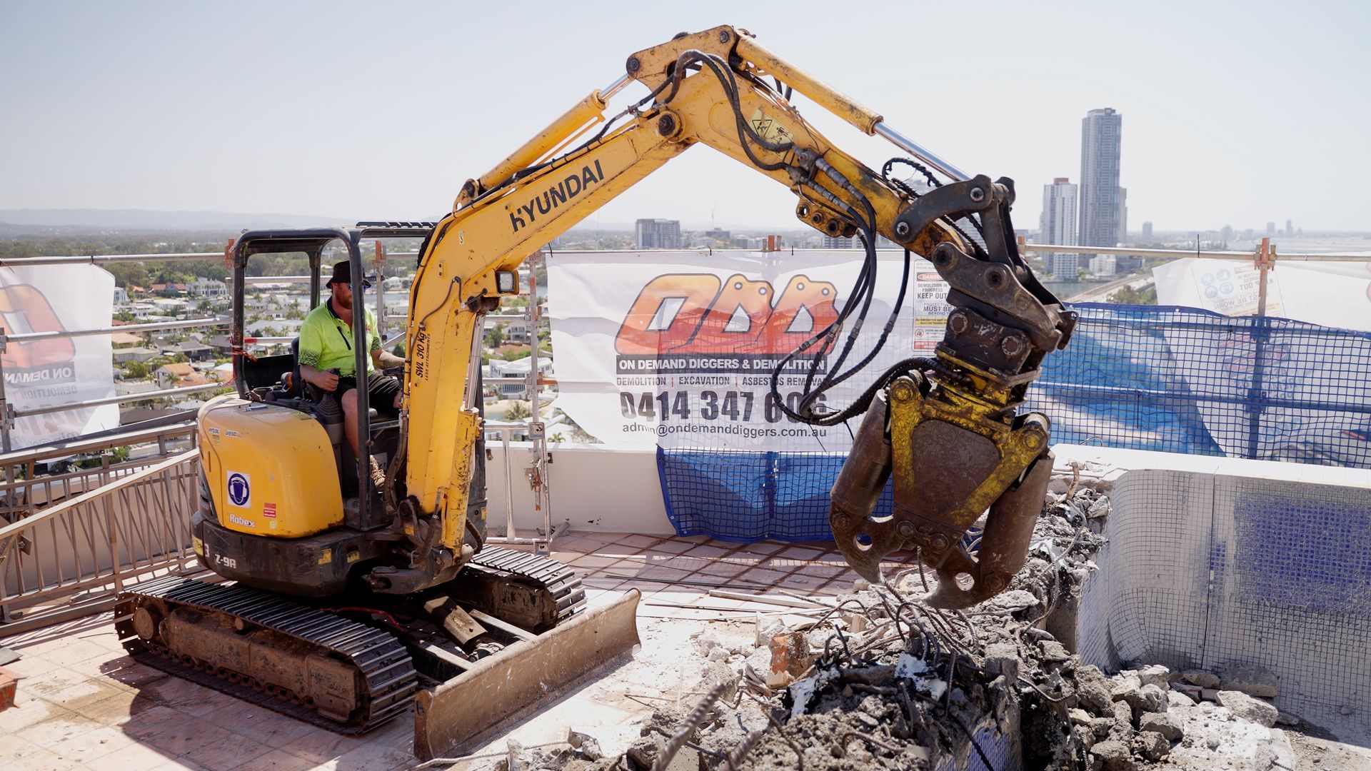 Orange Excavator Digging Dirt at a Construction Site — On Demand Diggers and Demolitions in Molendinar, QLD