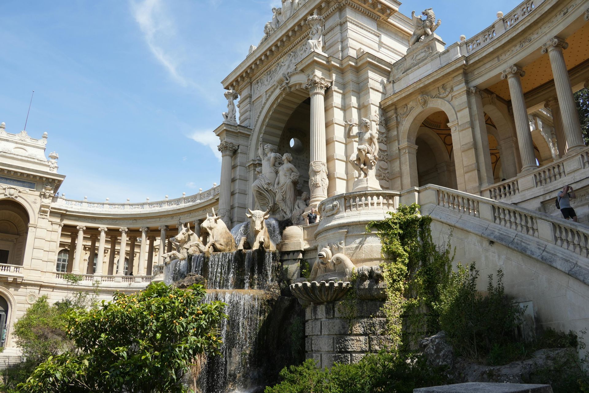 A large building with a waterfall in front of it