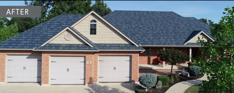 House with new blue roof and three garage doors. Landscaping in front.