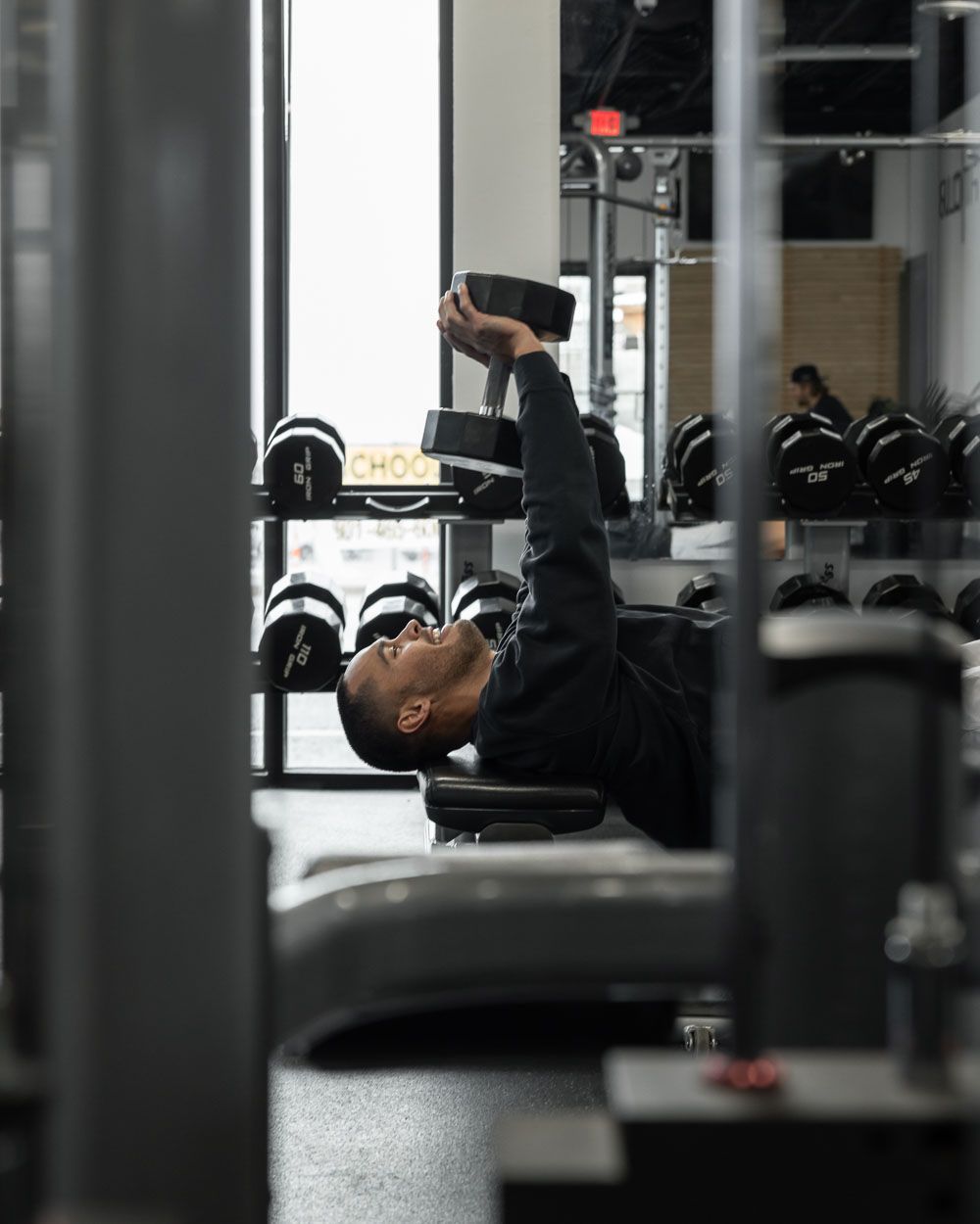 Strength training at FitClub in Salem, Utah, using weightlifting equipment.