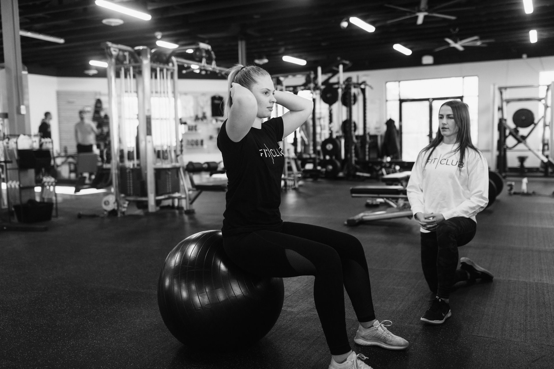 Personal training at FitClub in Salem, Utah, with core stability exercises.