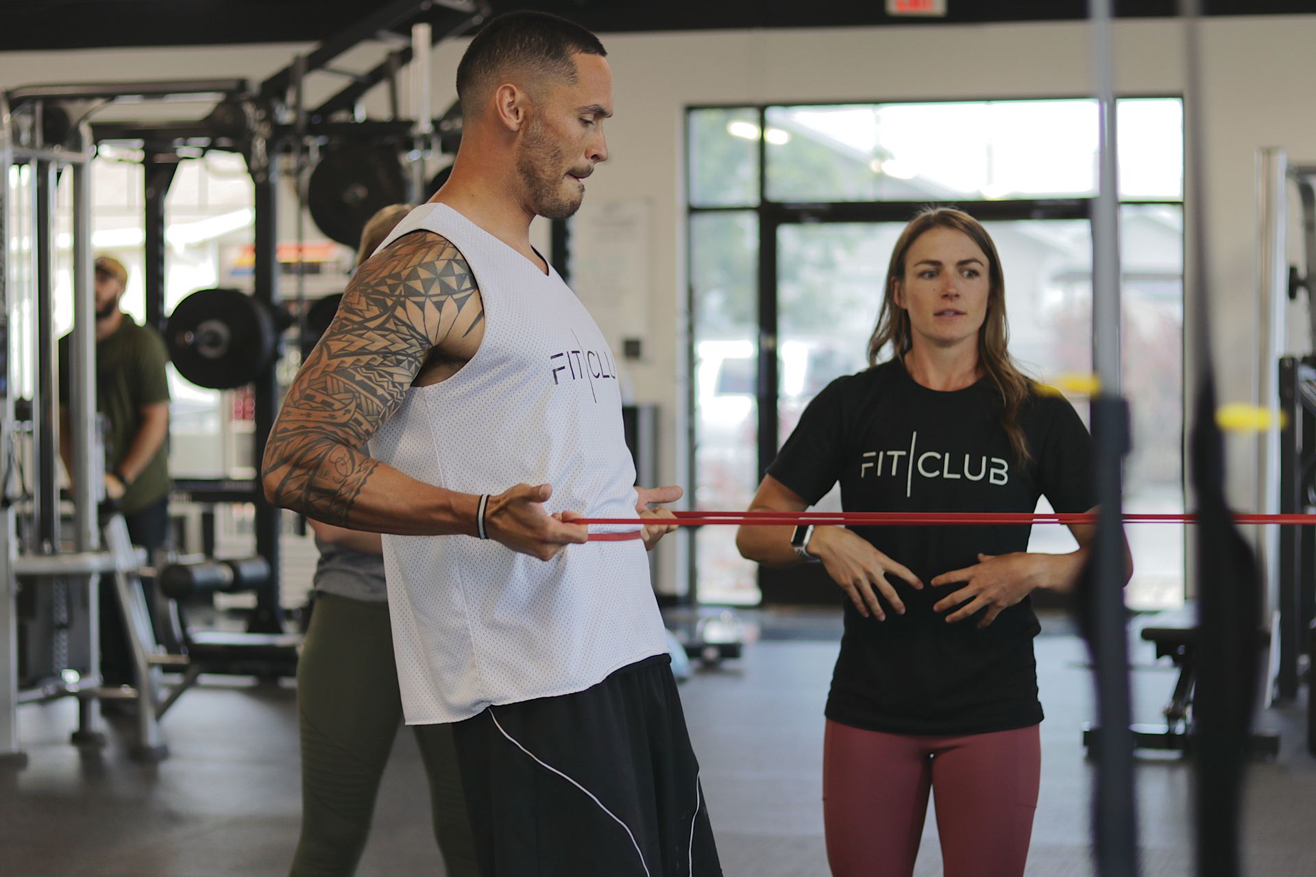 Personal training at FitClub in Salem, Utah, using resistance bands for strength training.