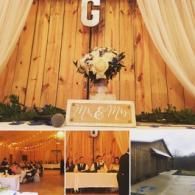 Rustic wedding decor with gold drapes, floral centerpiece, and small reception photo collage