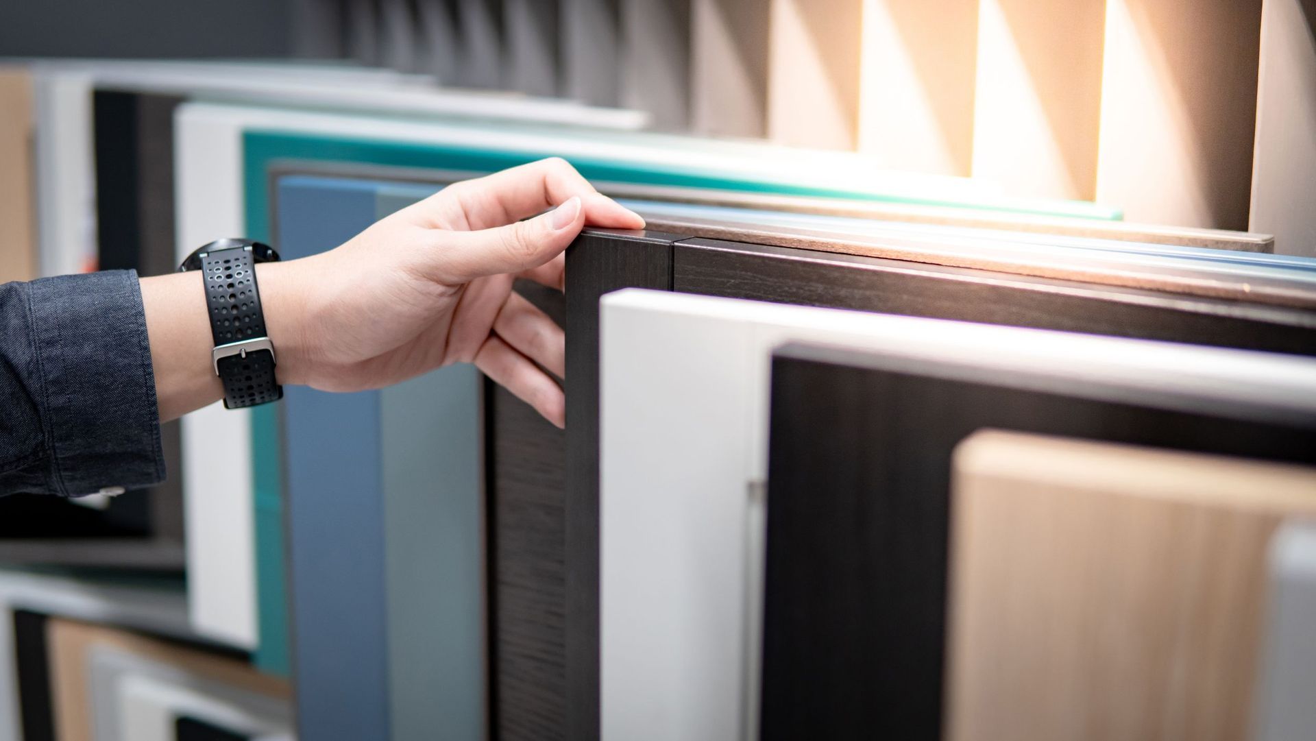 male hand choosing cabinet panel materials
