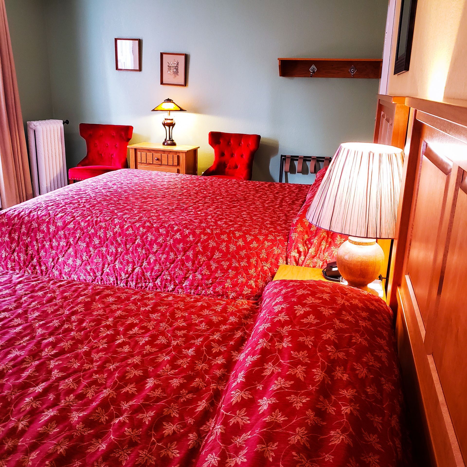 A hotel room with two beds and two lamps