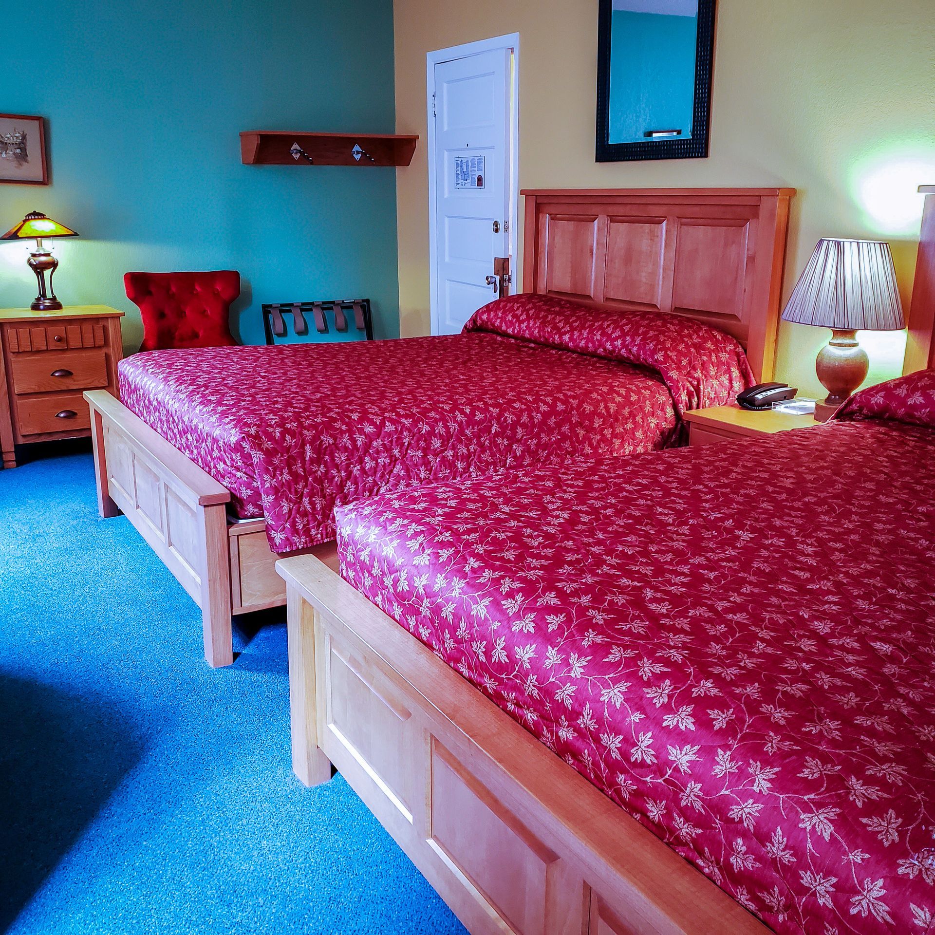 A hotel room with two beds and two lamps