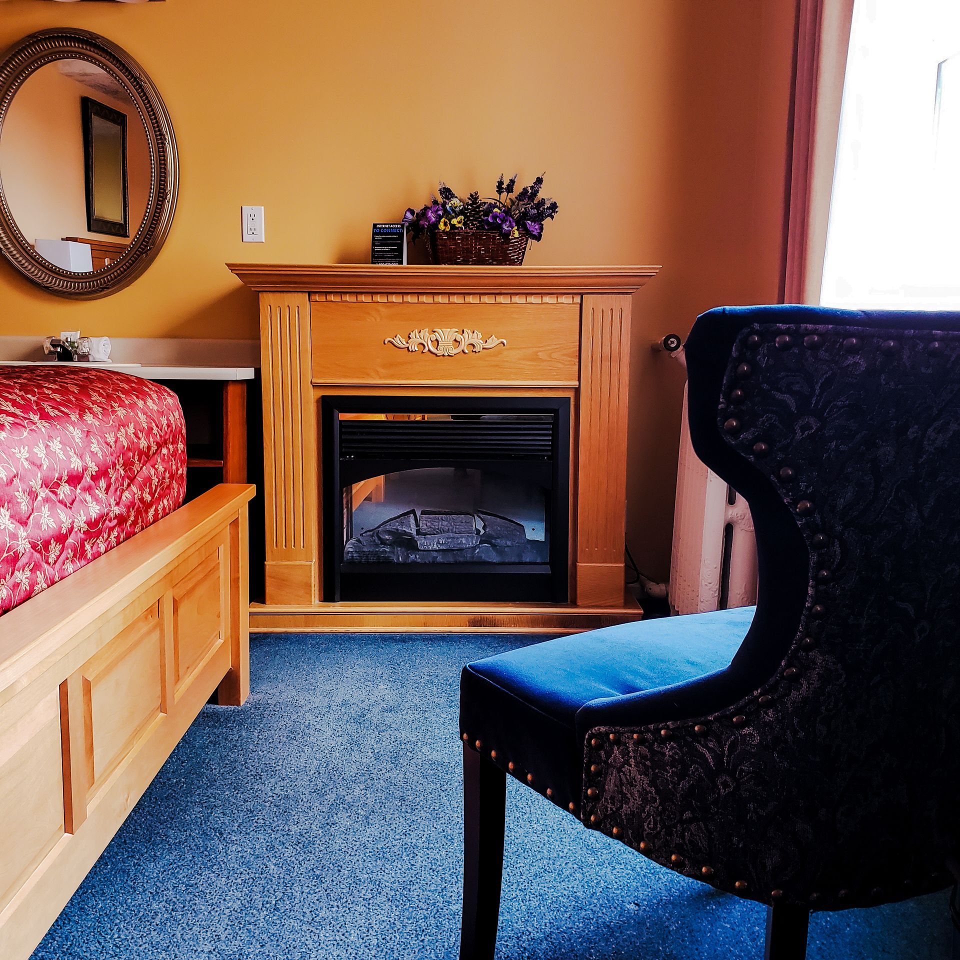 A bedroom with a fireplace and a chair