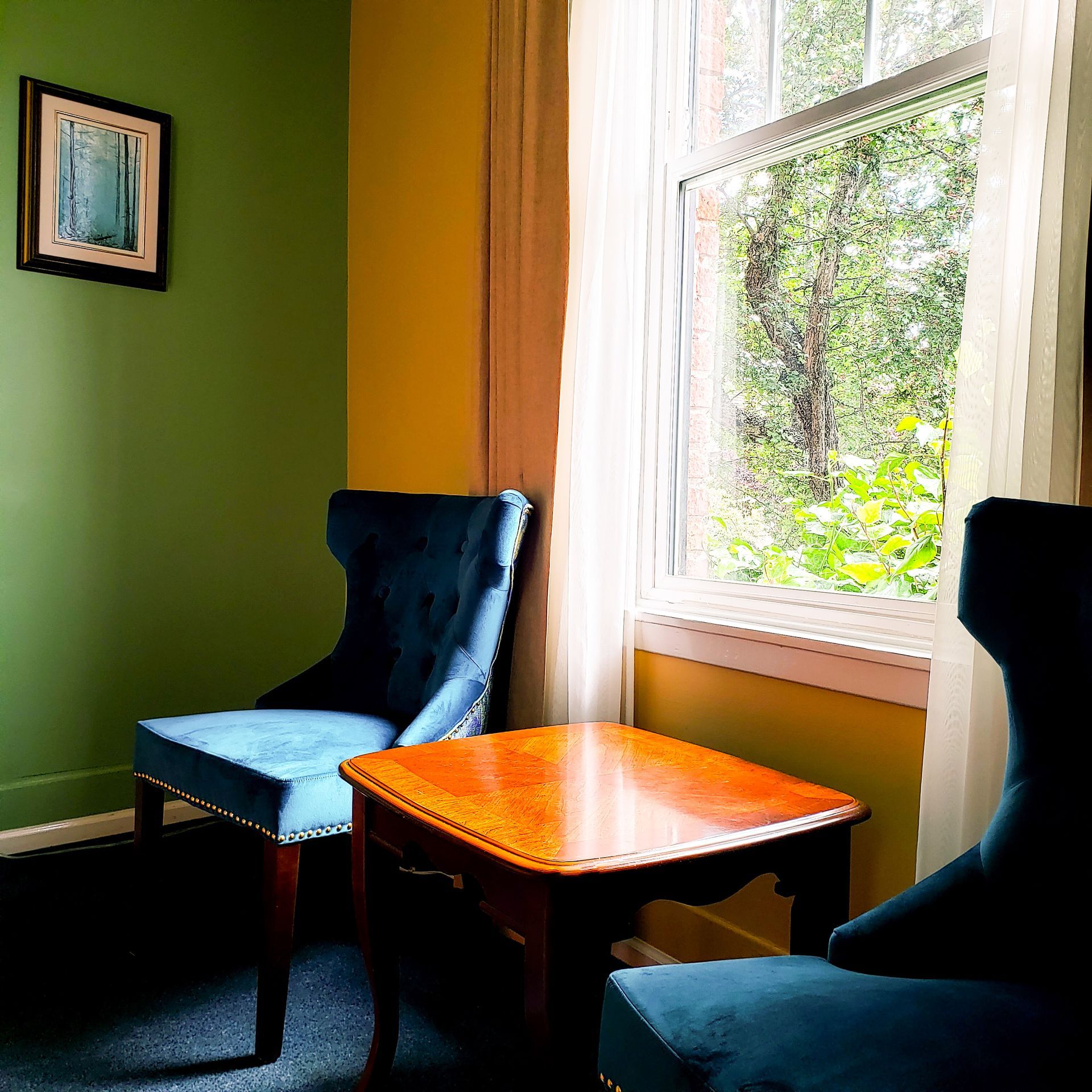 Two chairs and a table in front of a window