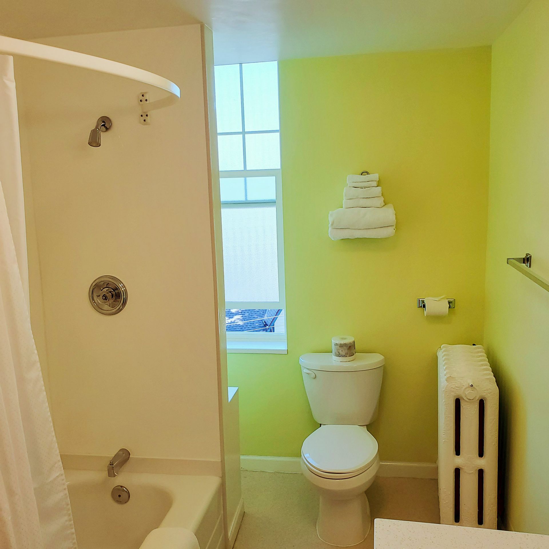 A bathroom with yellow walls and a toilet