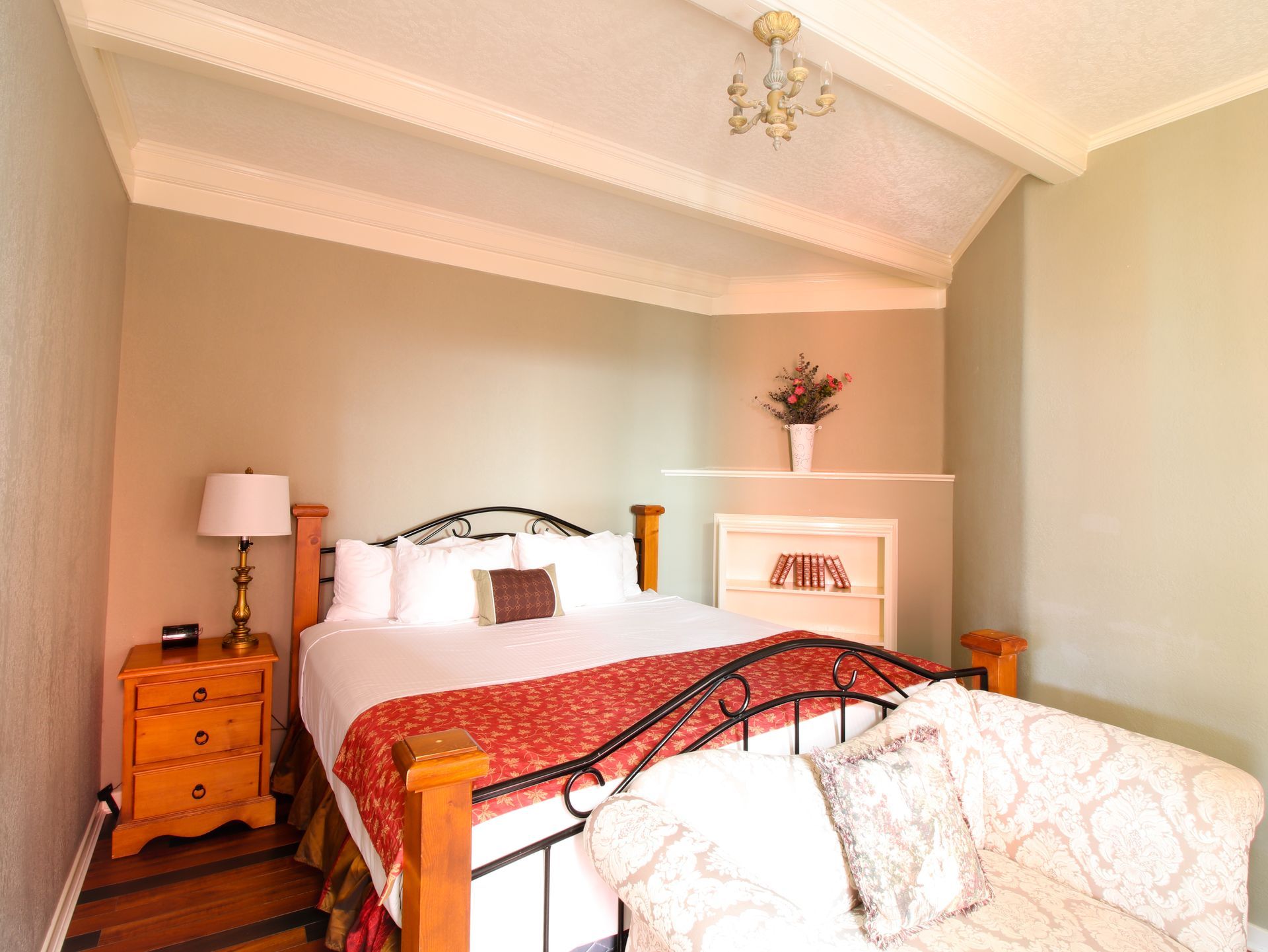 A bedroom with a king size bed and a couch
