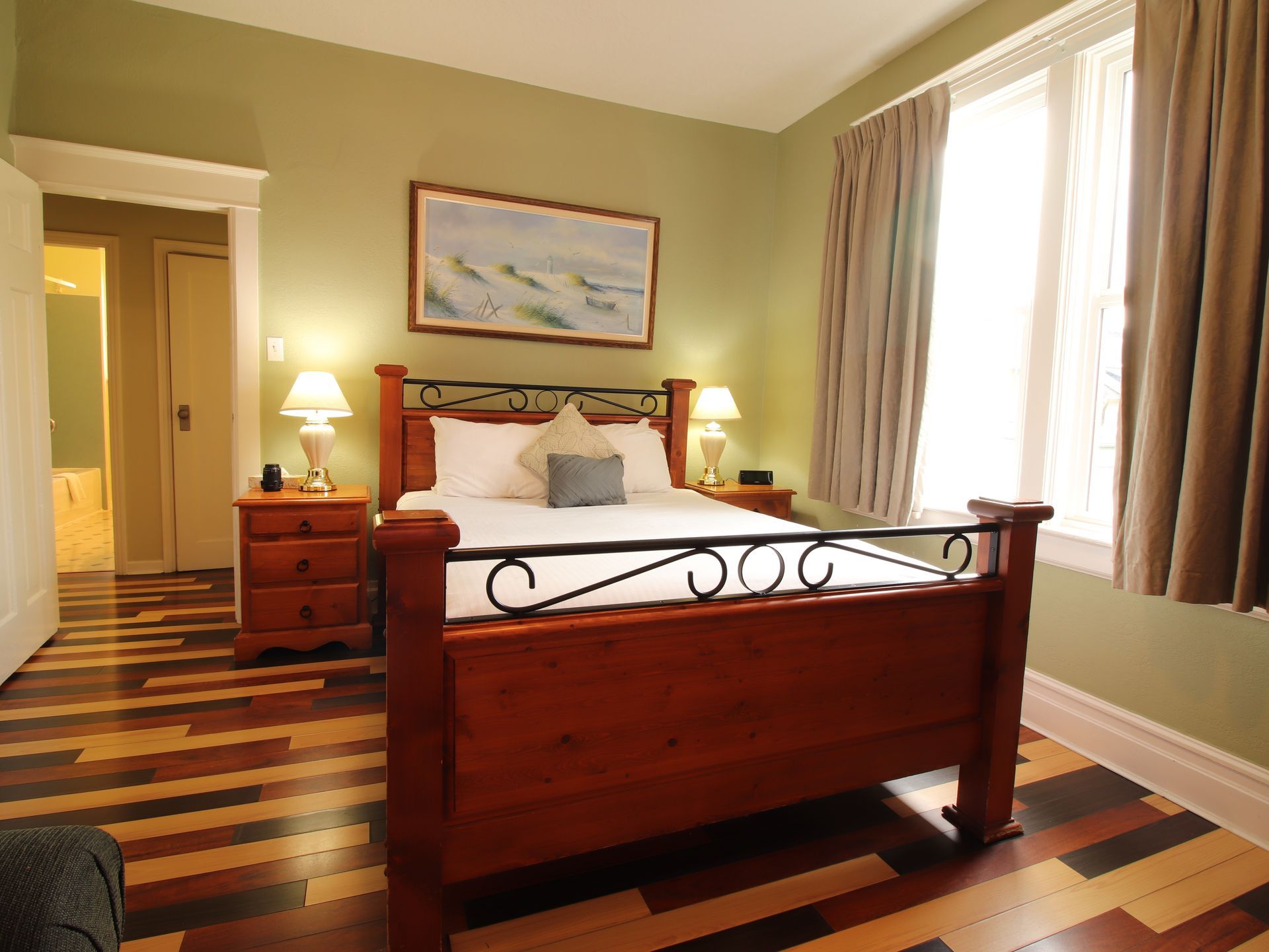 A bedroom with a wooden bed and a wooden floor