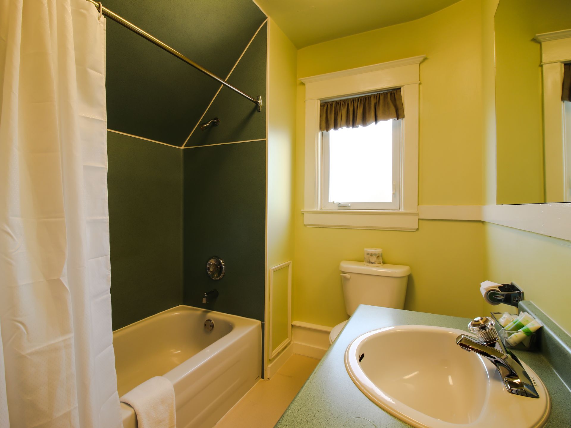 A bathroom with a tub sink and toilet