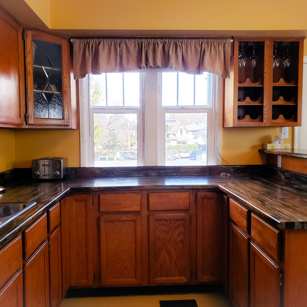 A kitchen with wooden cabinets and granite counter tops
