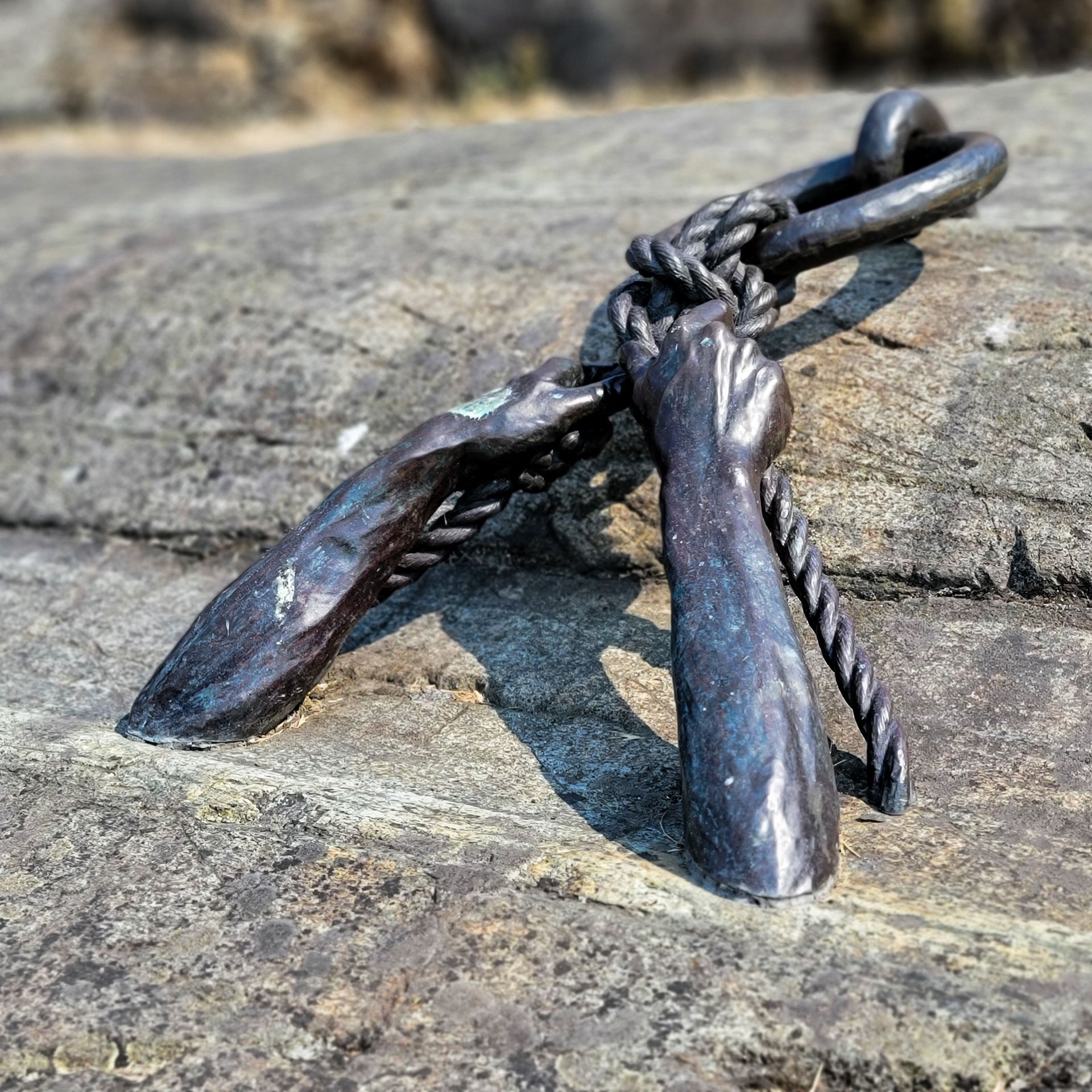 A close up of a metal object on a rock.