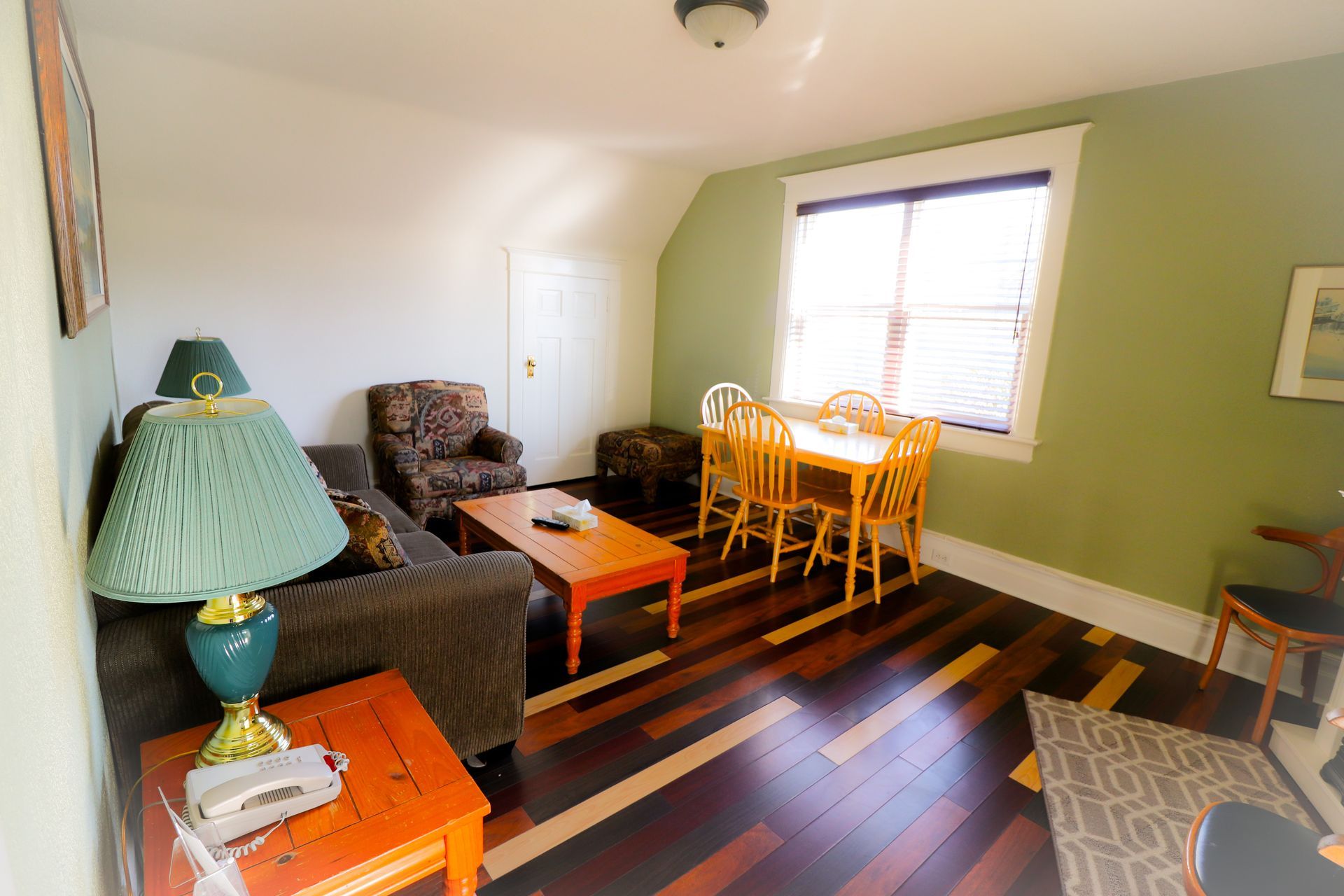 A living room with a couch a table and chairs