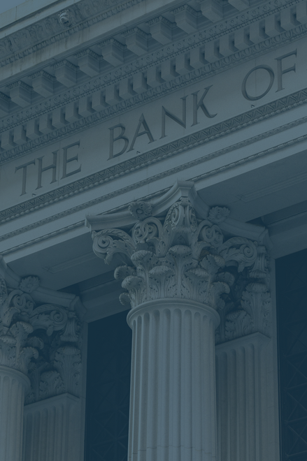 Exterior of bank building with ornate columns and the words