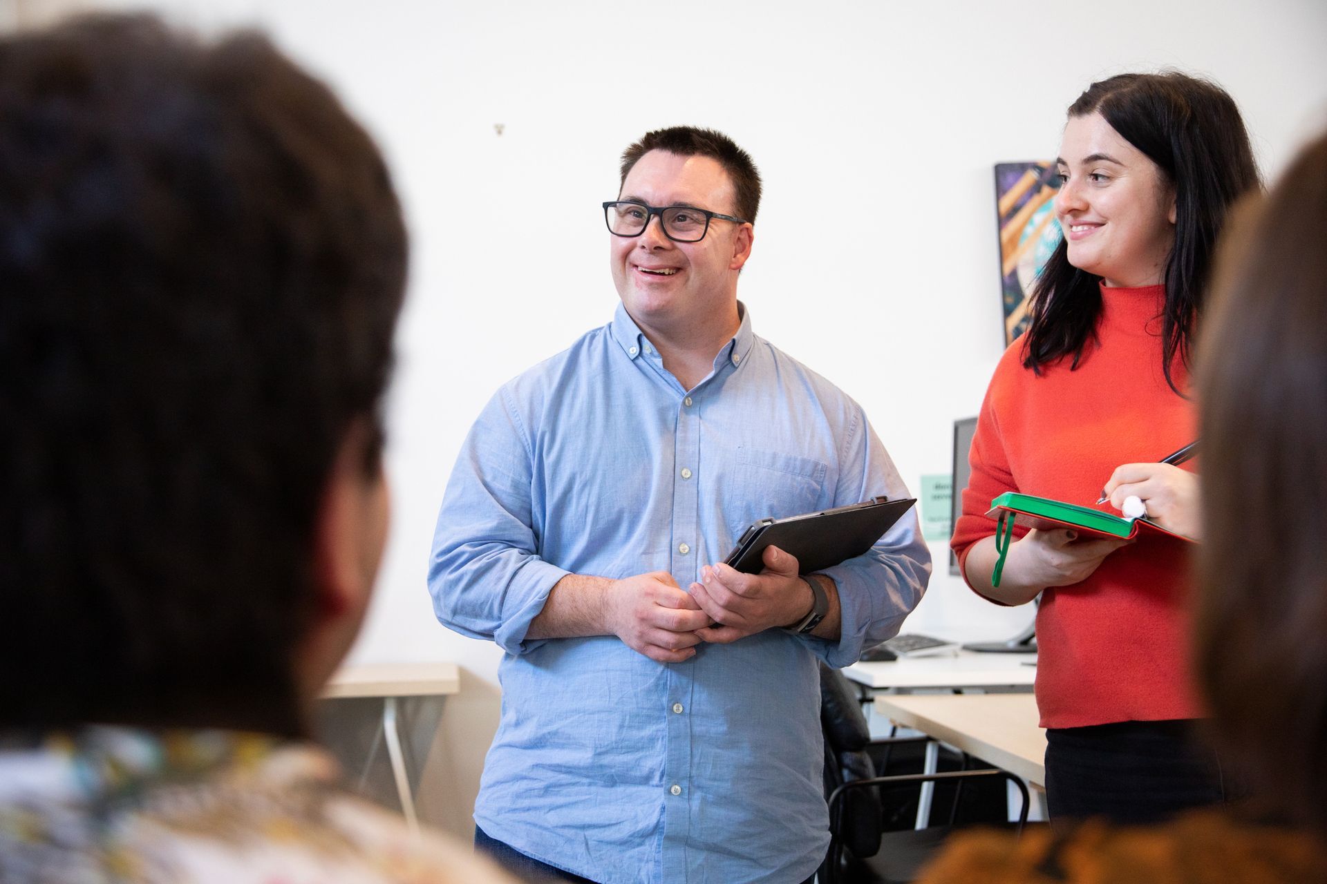 A man and a woman are standing next to each other in a room.