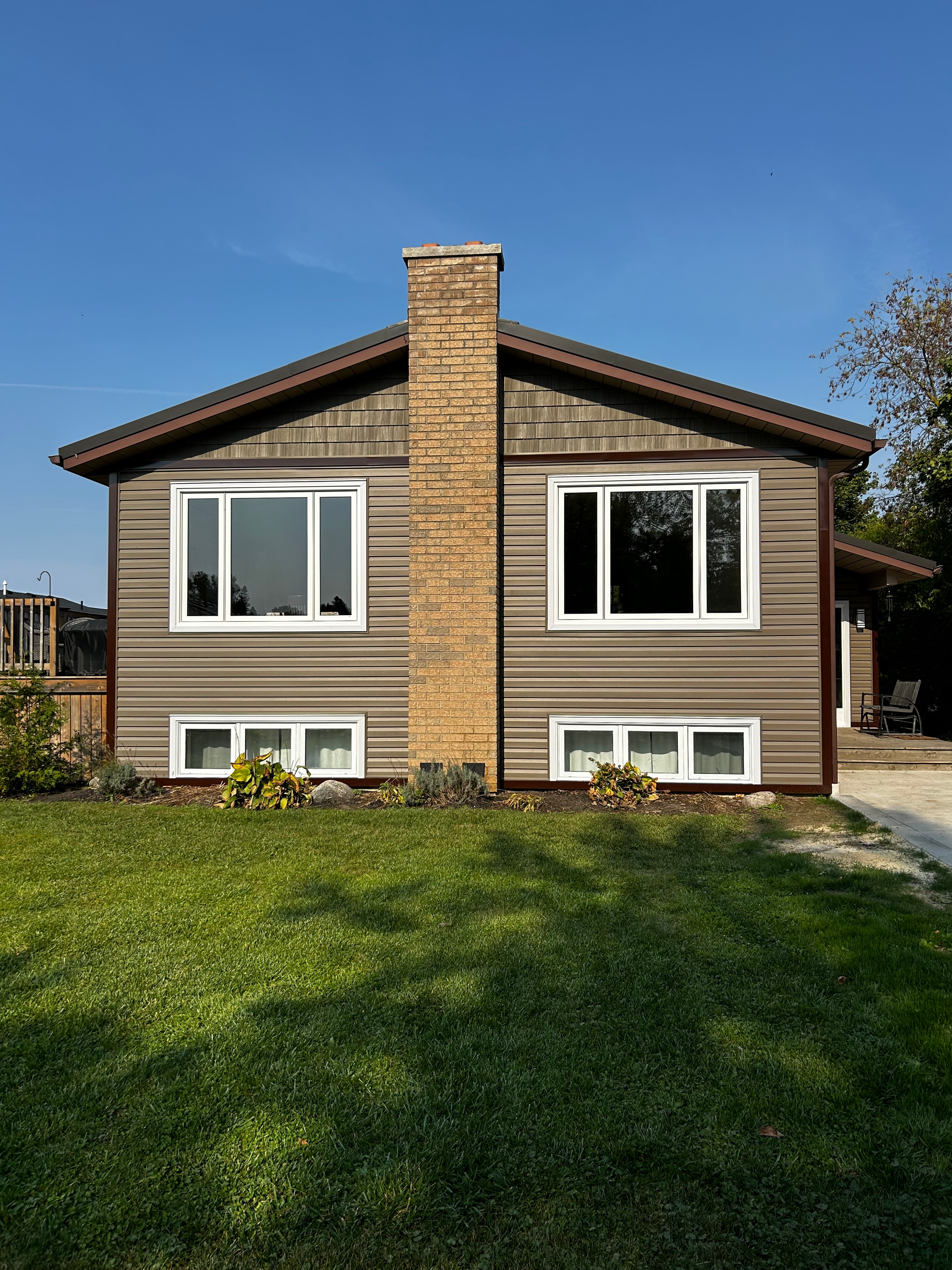 A house with a lot of windows and a chimney