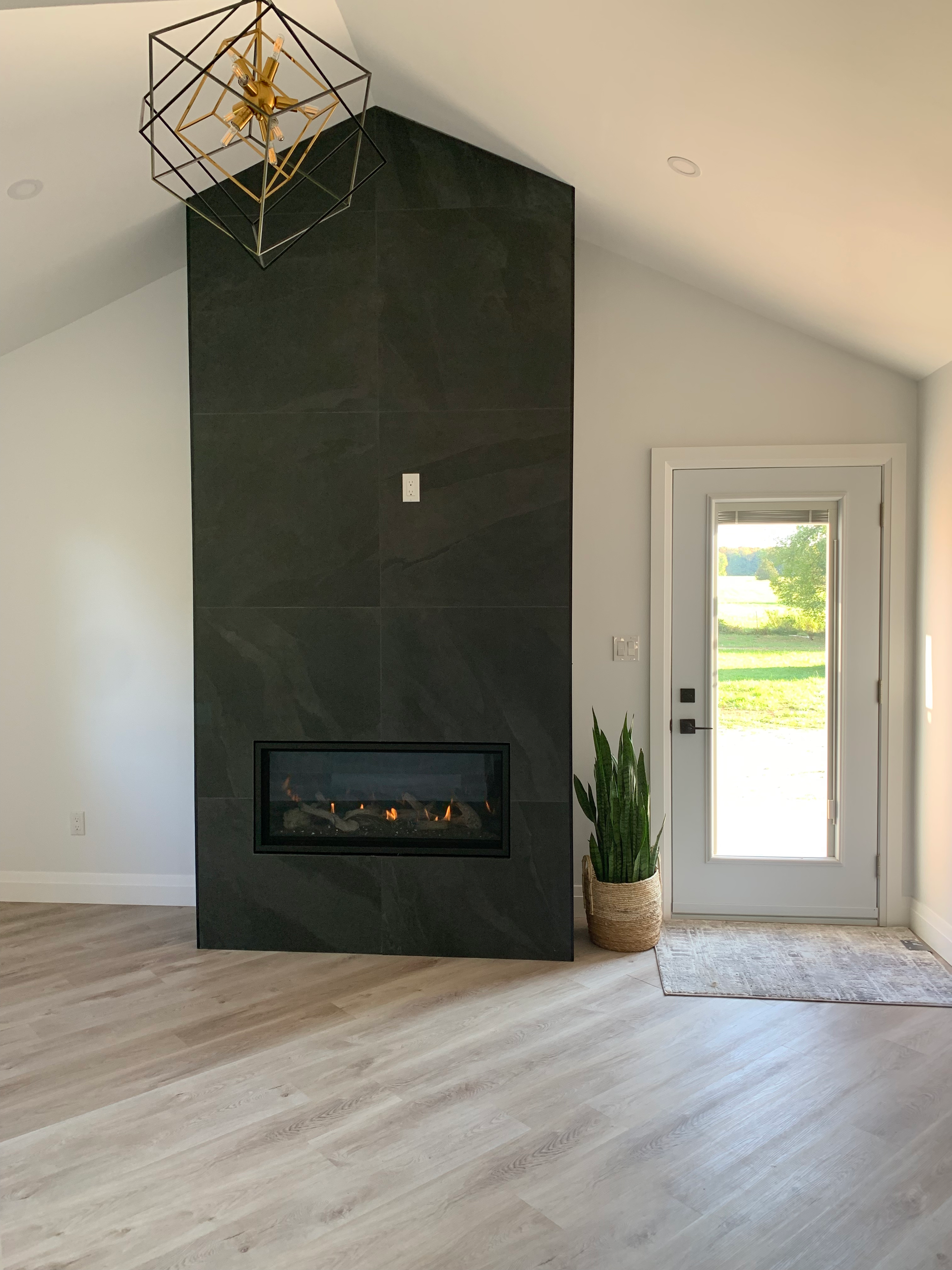 A living room with a fireplace and a door.