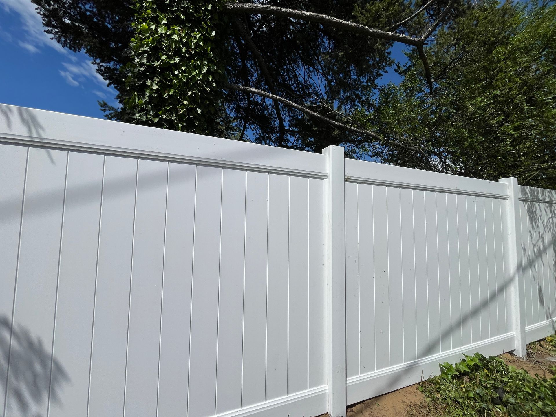 Completed white vinyl privacy fence installation in Burlington County NJ