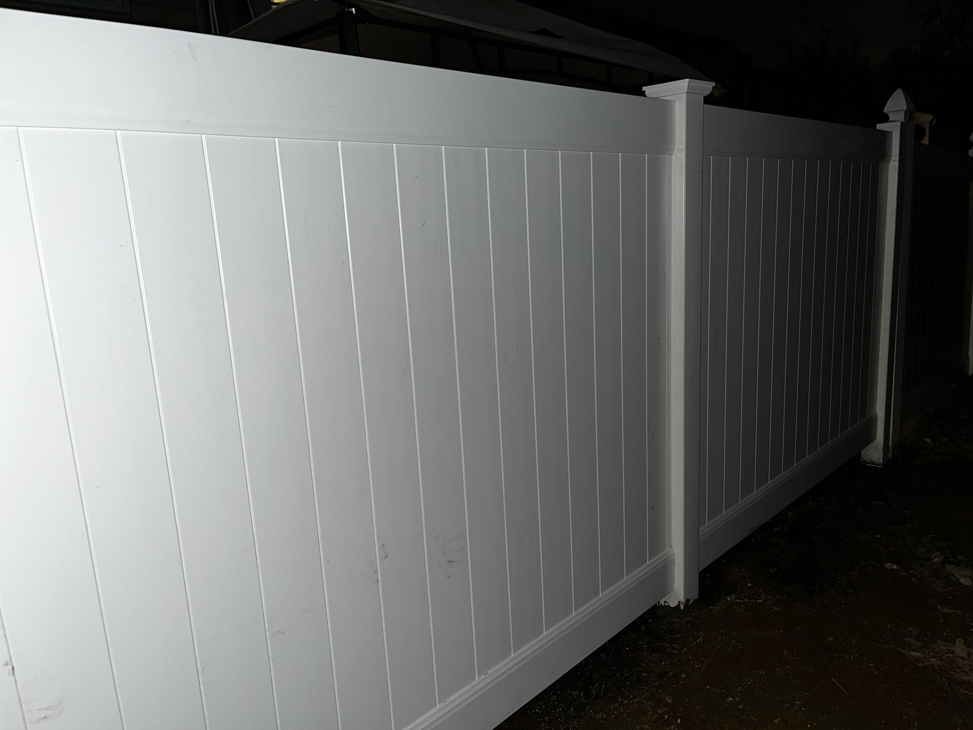 Close-up white vinyl fence panel installation in Burlington County NJ