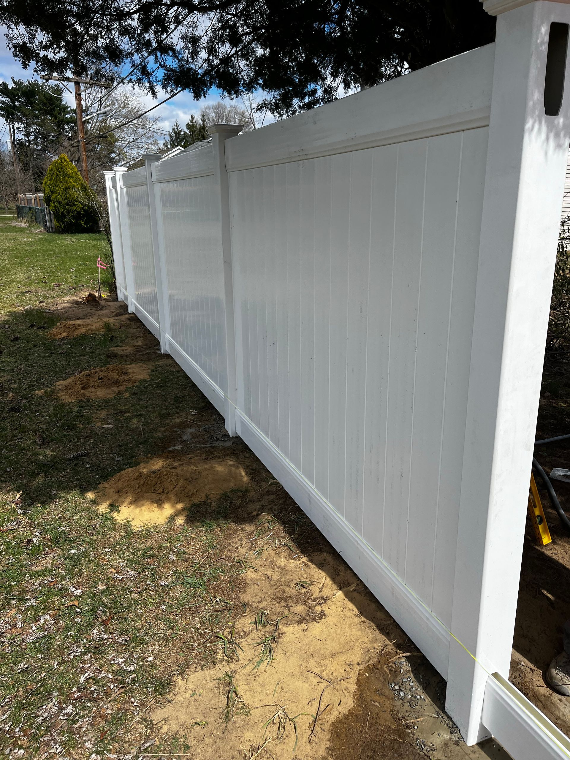Long white vinyl fence line installation in Burlington County NJ