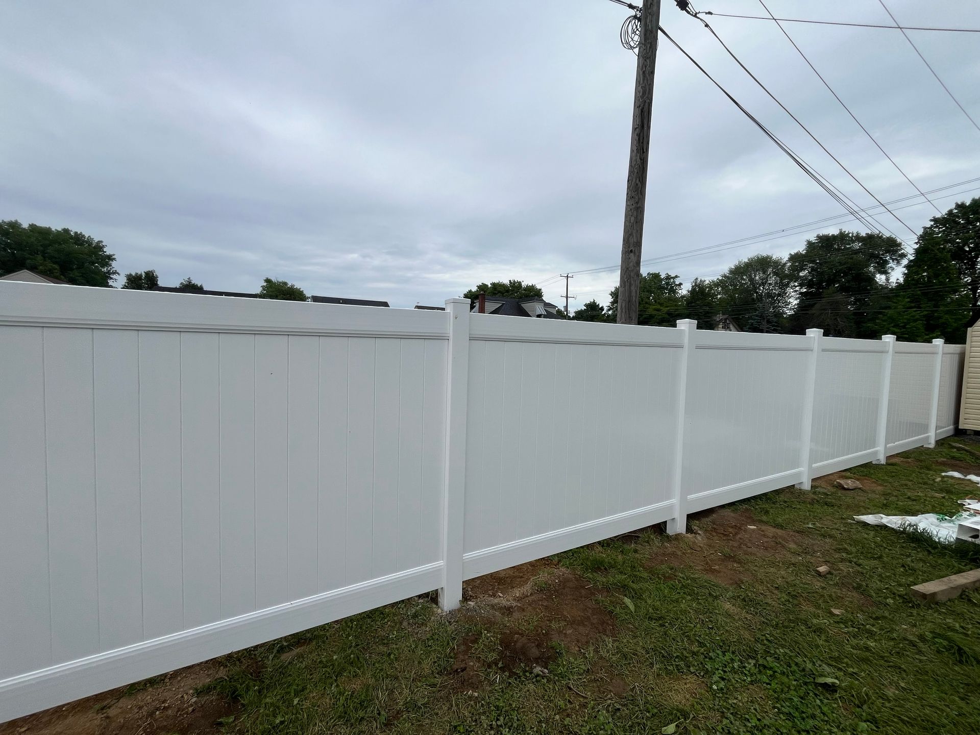 Wide residential white vinyl fence line in Burlington County NJ