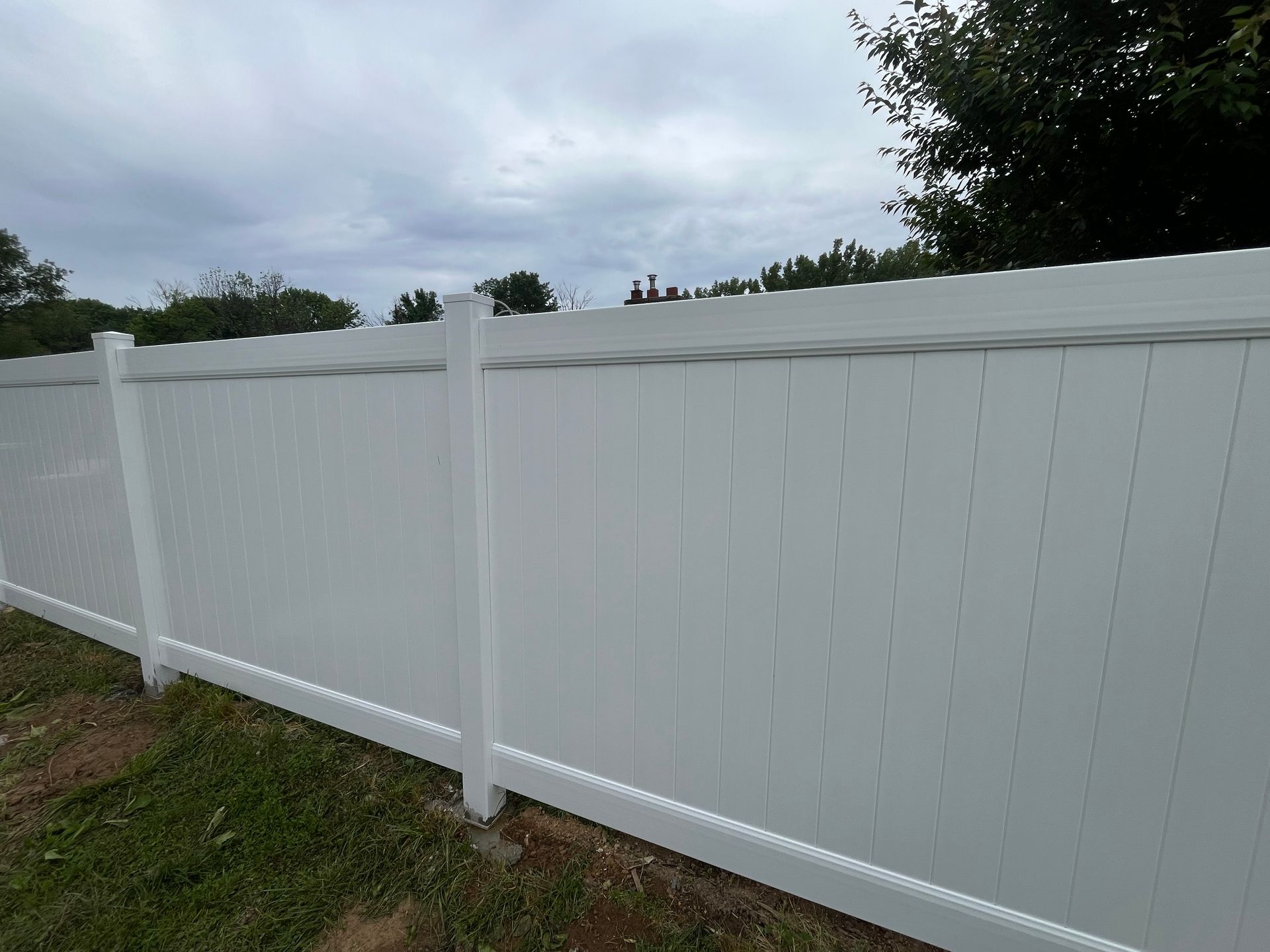 Completed backyard white vinyl privacy fence project in Burlington County NJ