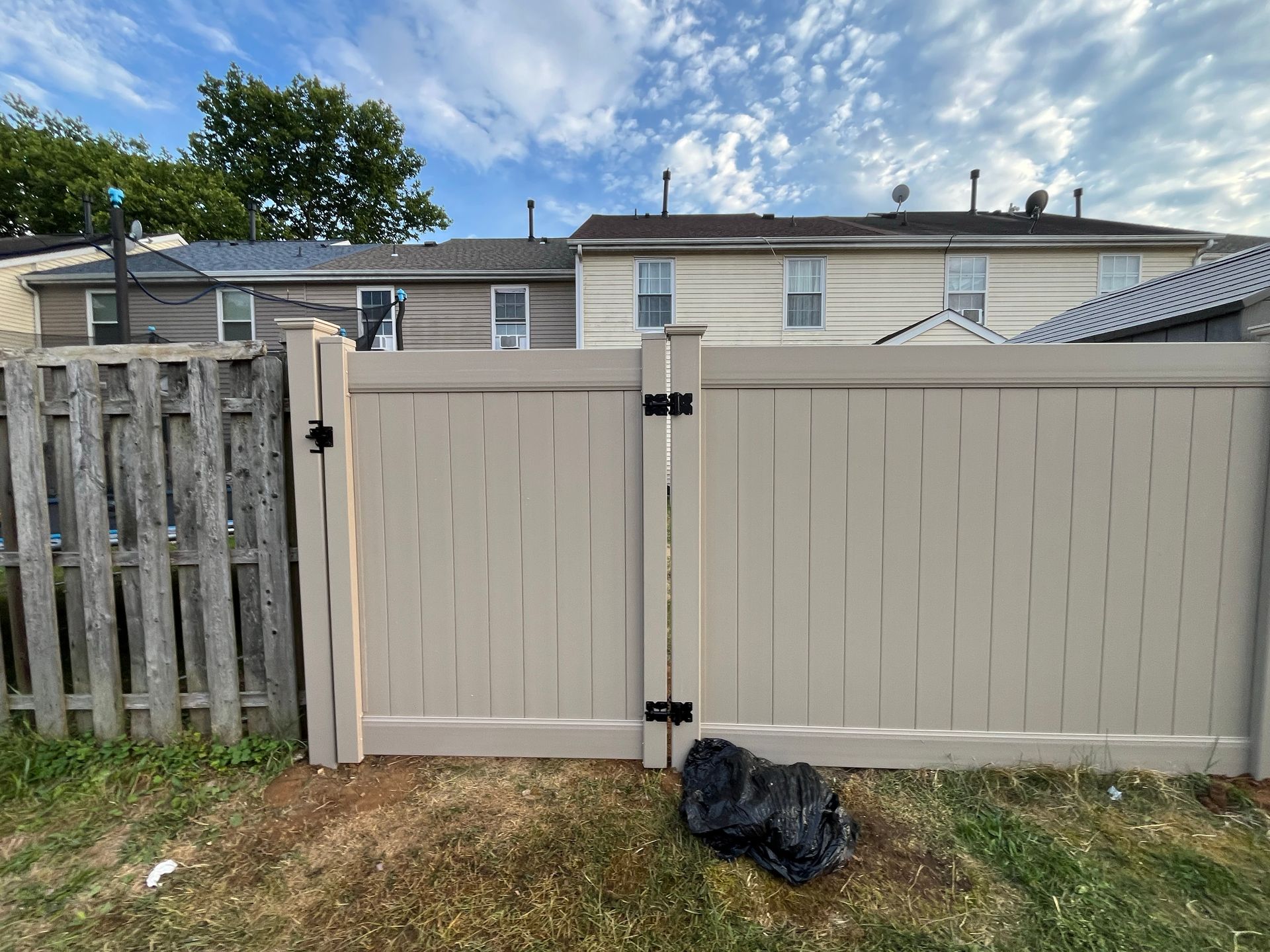 Tan vinyl privacy fence gate installation in Burlington County NJ