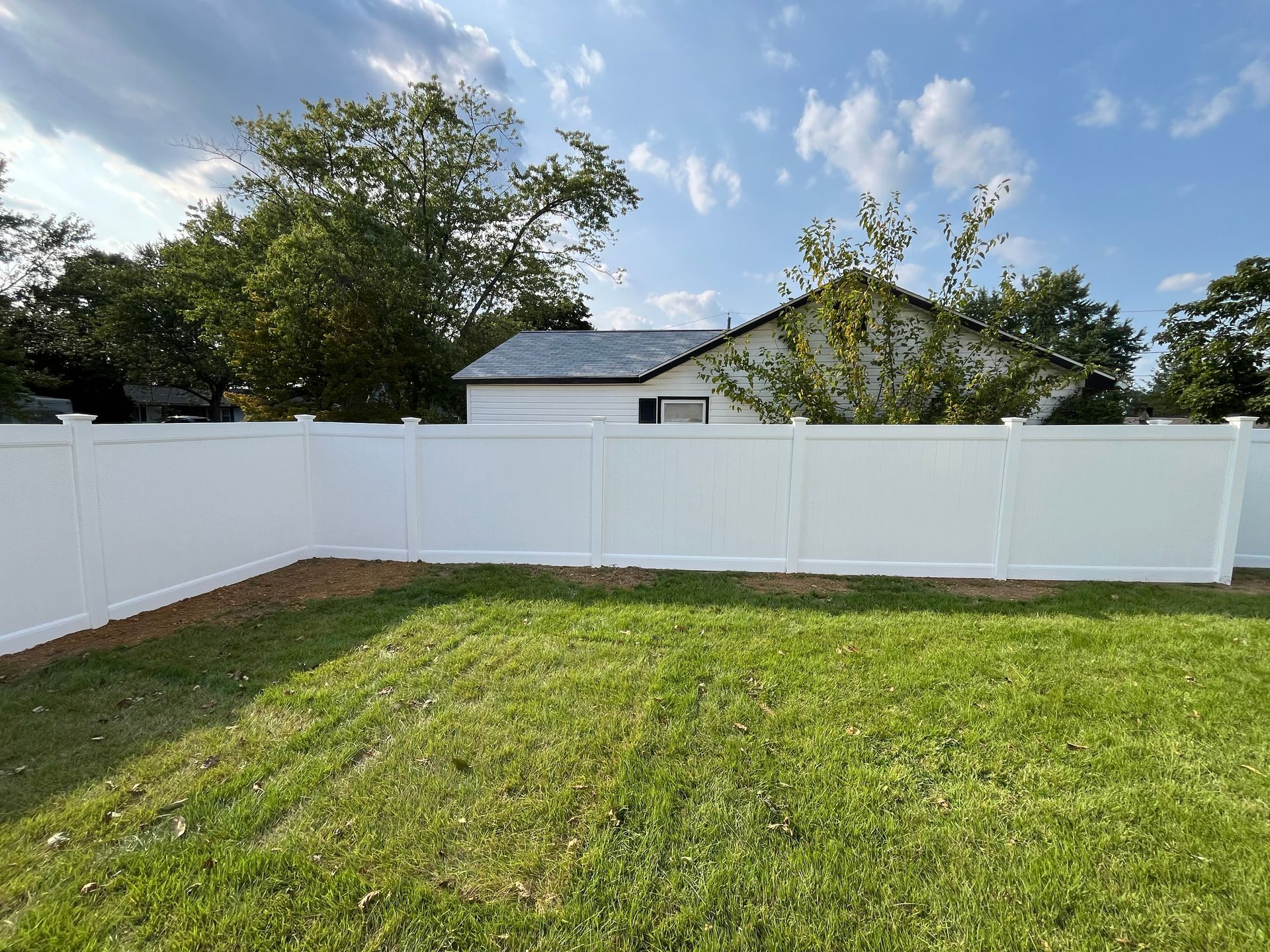 Wide backyard white vinyl privacy fence with lattice top in Burlington County NJ