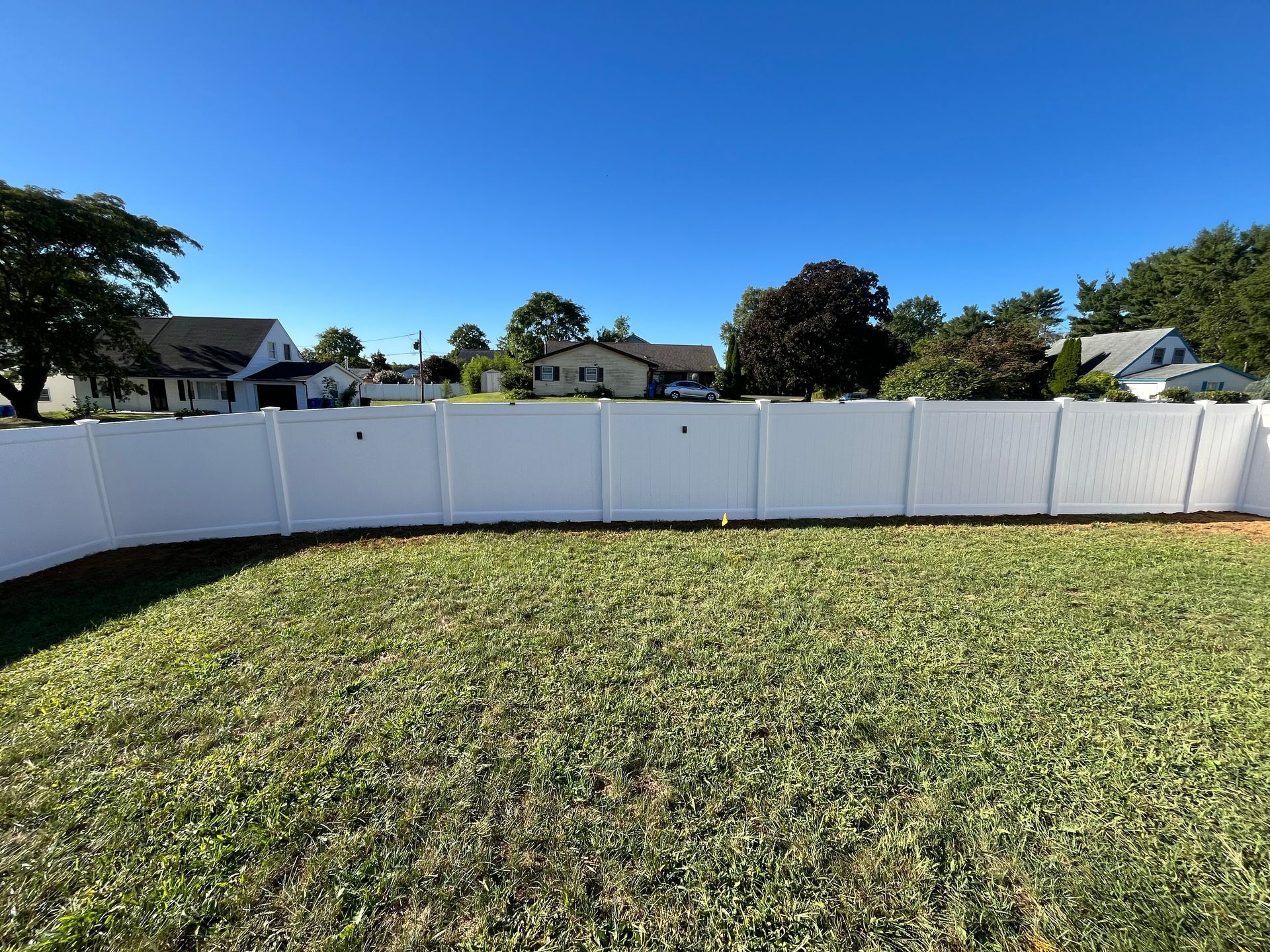 Wide full-yard white vinyl fence installation in Burlington County NJ