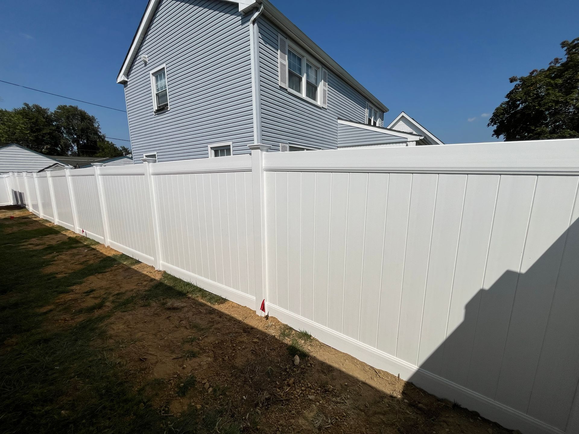 Long white vinyl privacy fence line in Burlington County NJ